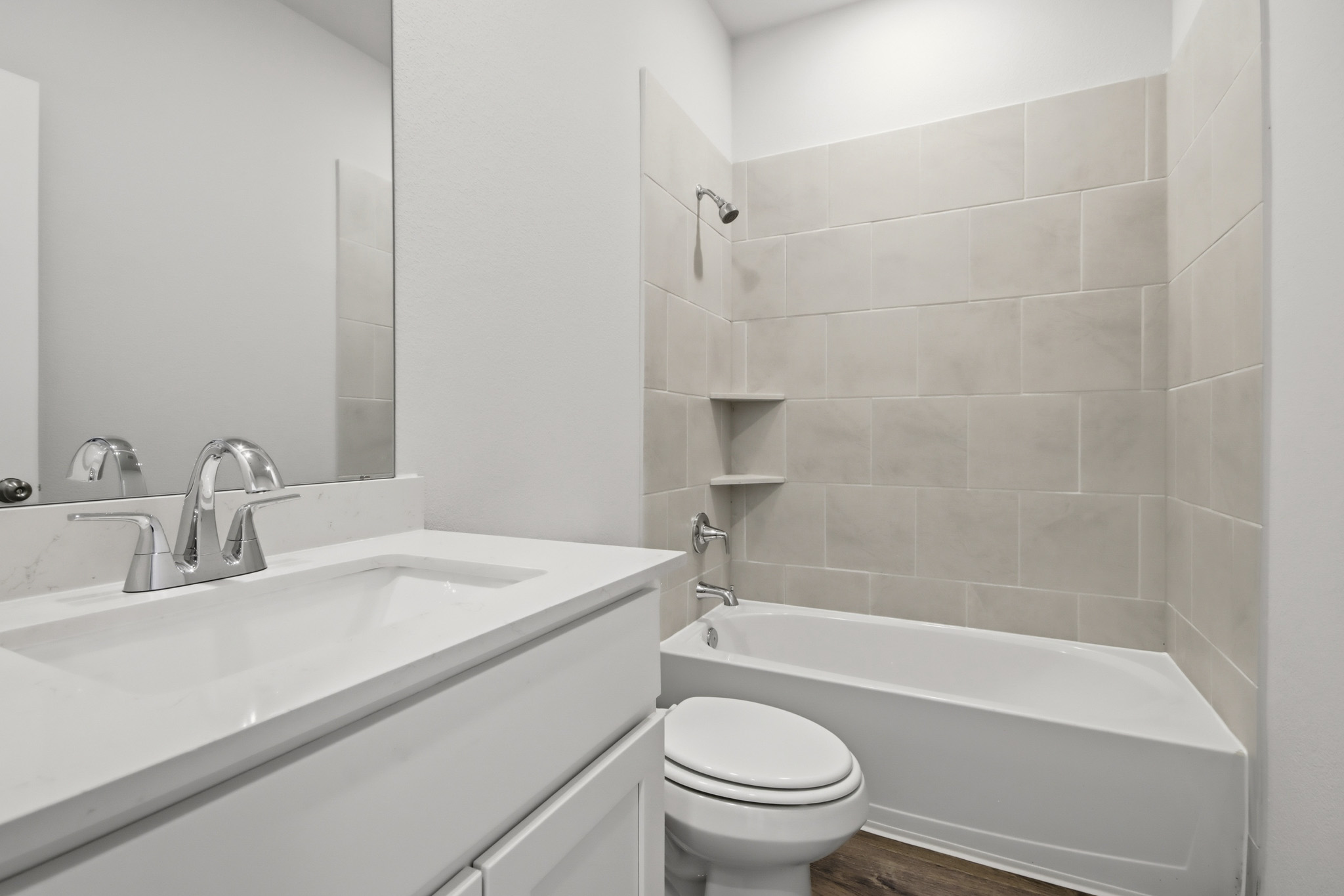 A bathroom with a tub toilet and sink.