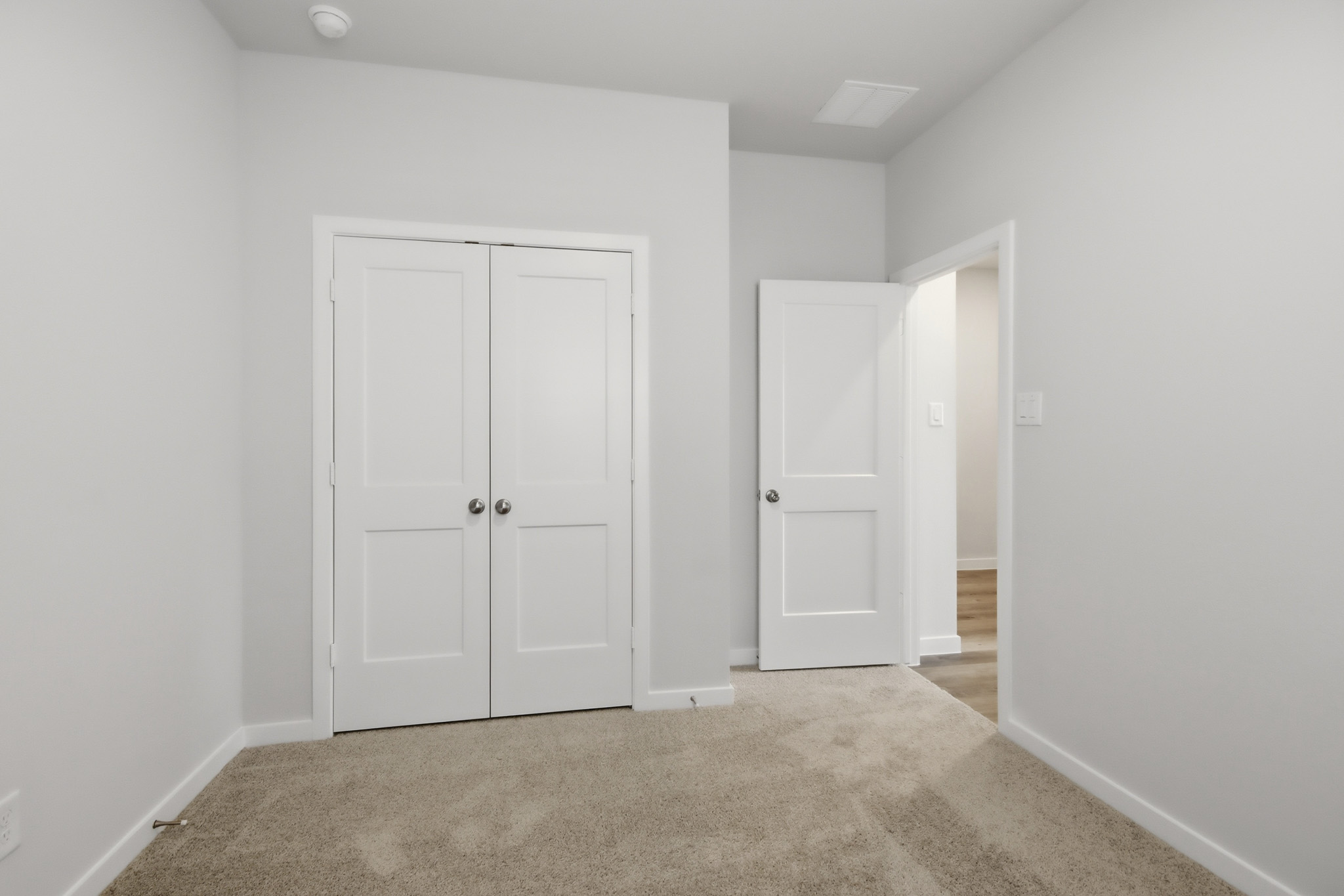 A hallway with white doors.