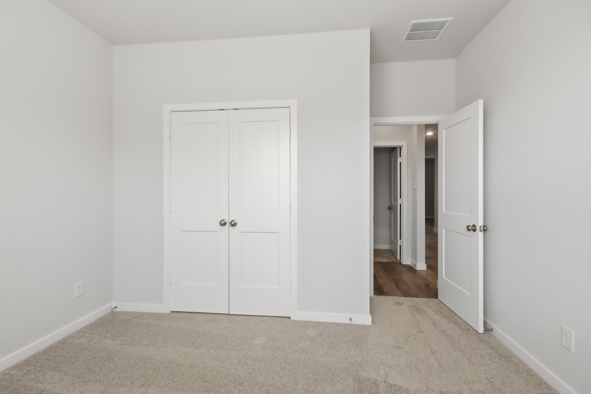 A hallway with white doors.