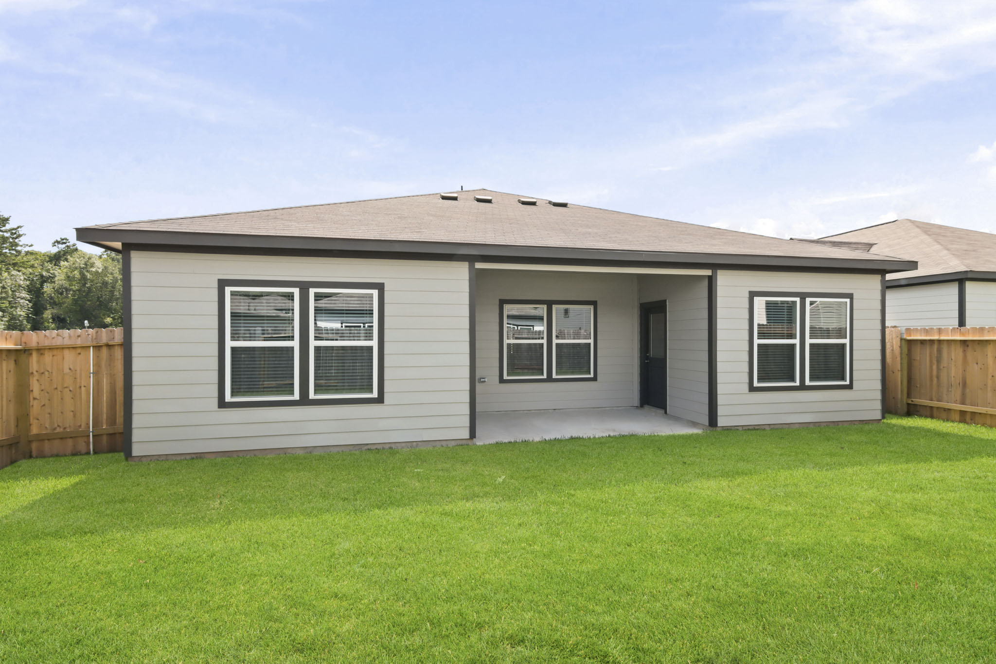 A house with a fence and grass.