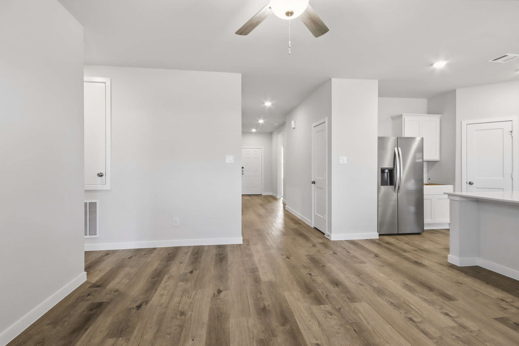 A kitchen with white cabinets.