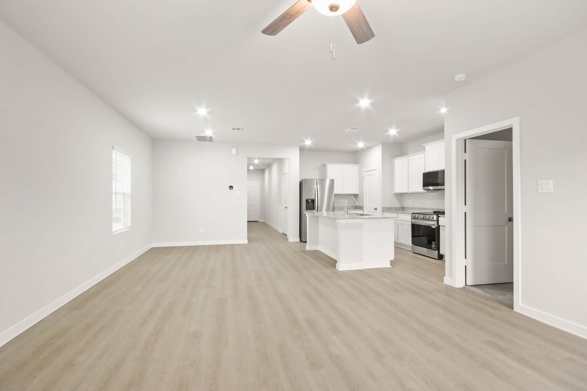 A large kitchen with white cabinets.