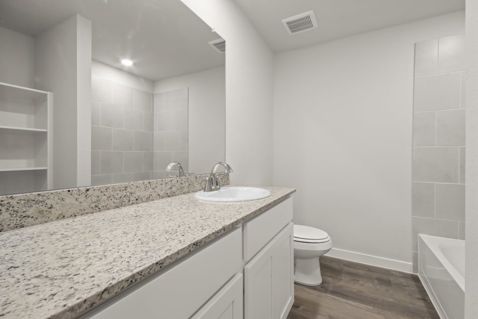 A bathroom with a marble countertop.