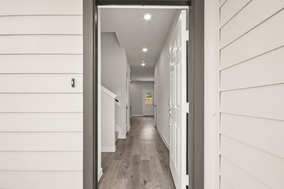 A hallway with white walls.