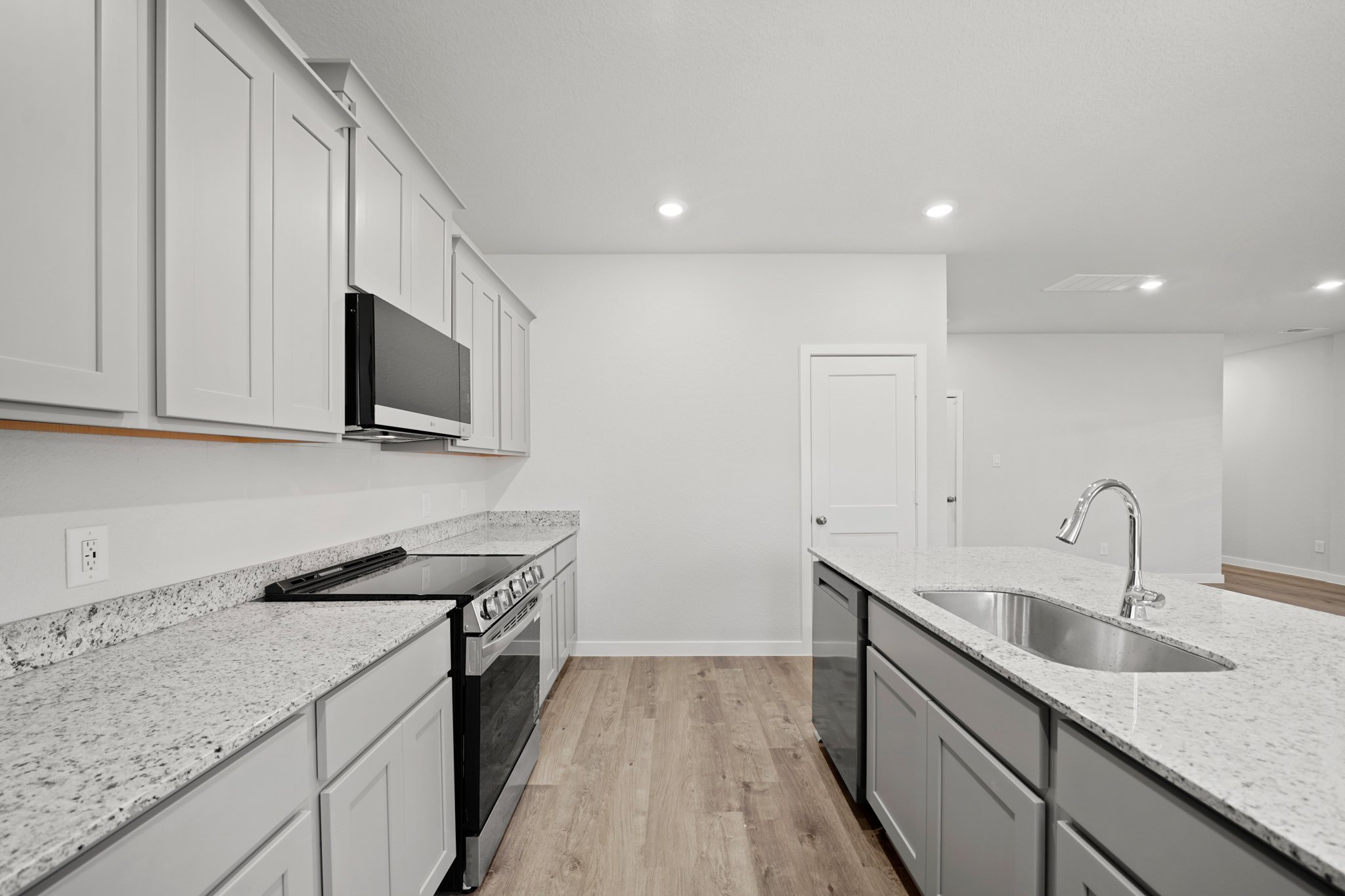 A kitchen with white cabinets.