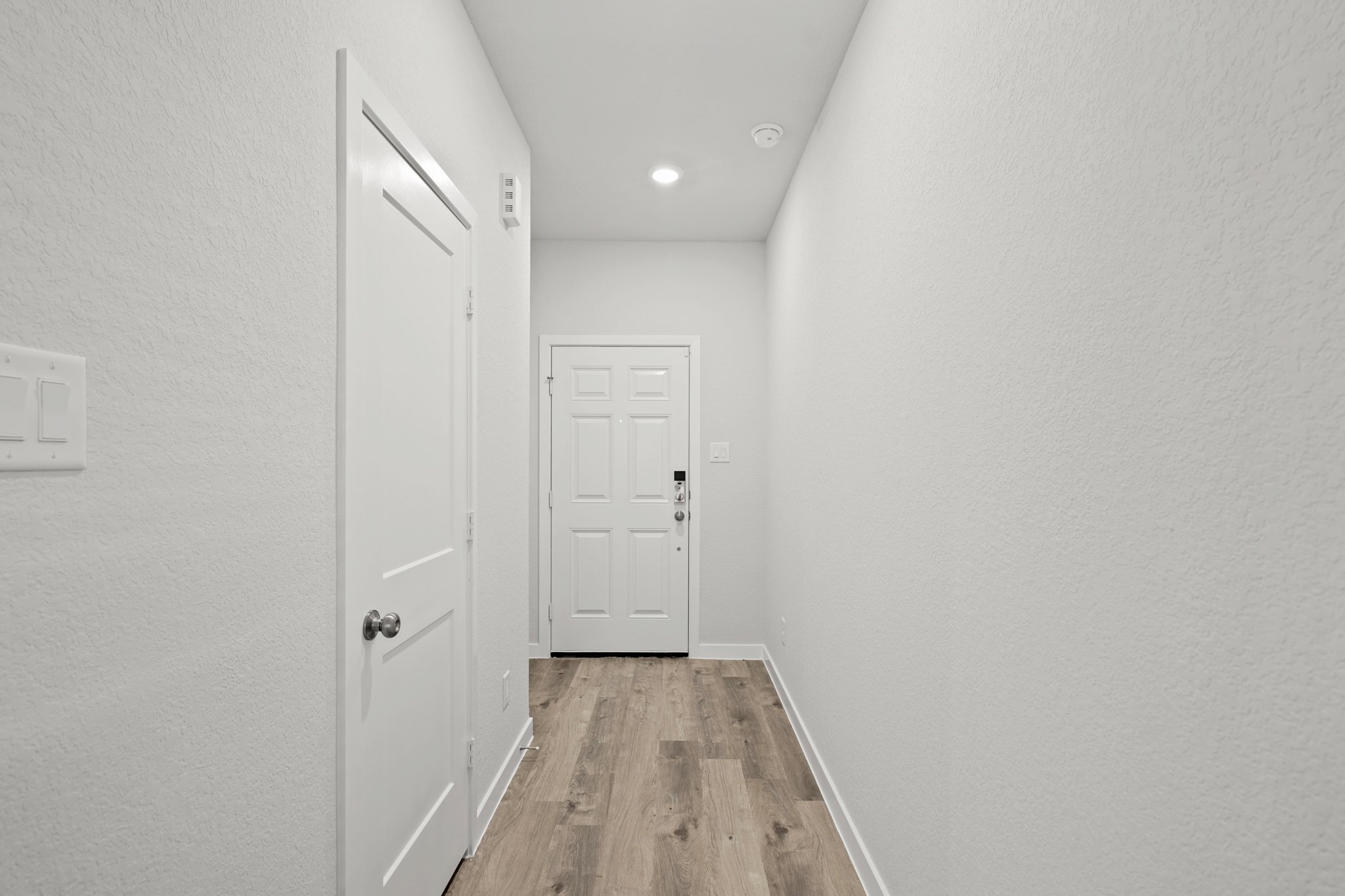 A hallway with white doors.
