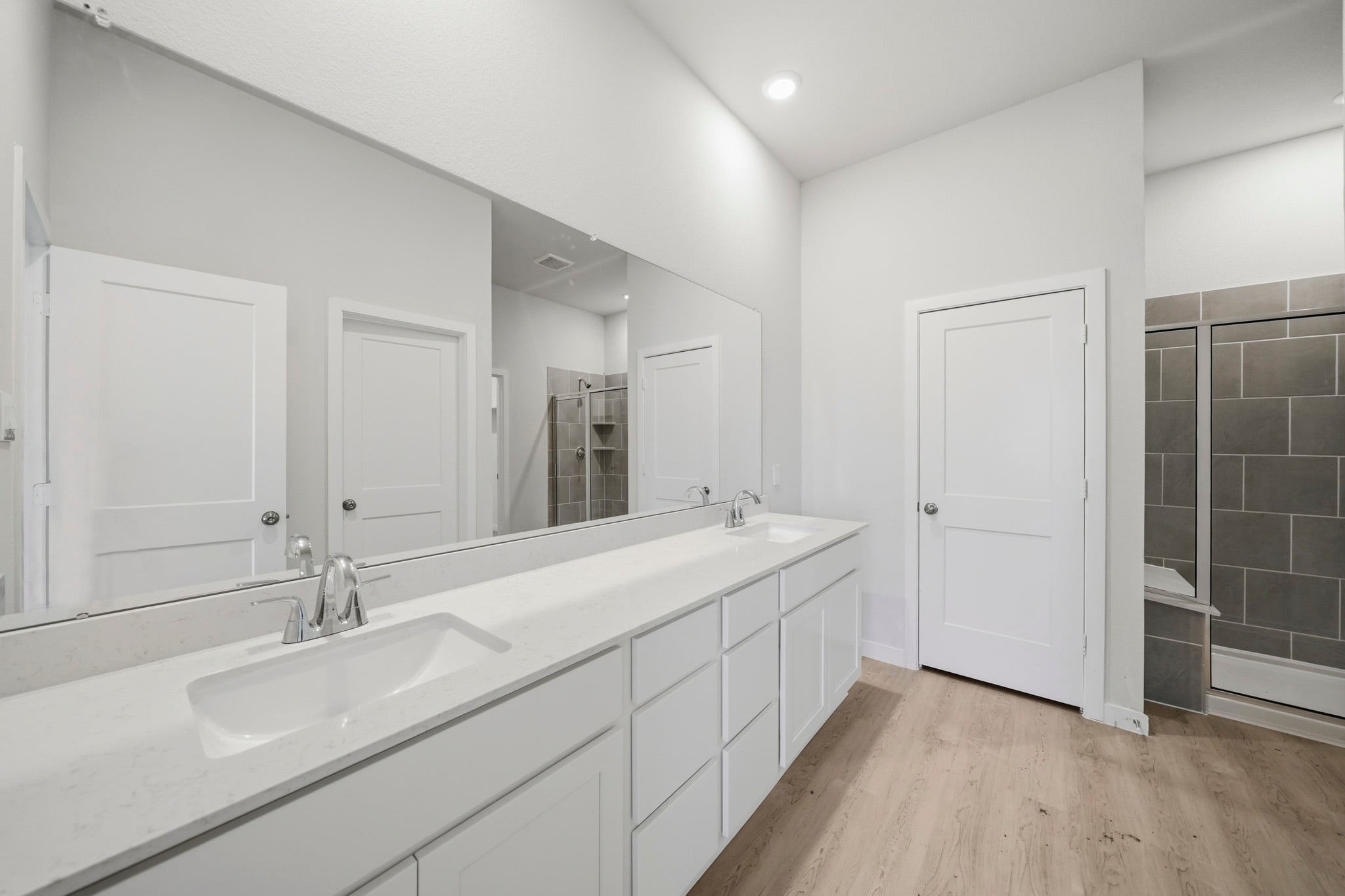 A bathroom with a large mirror.