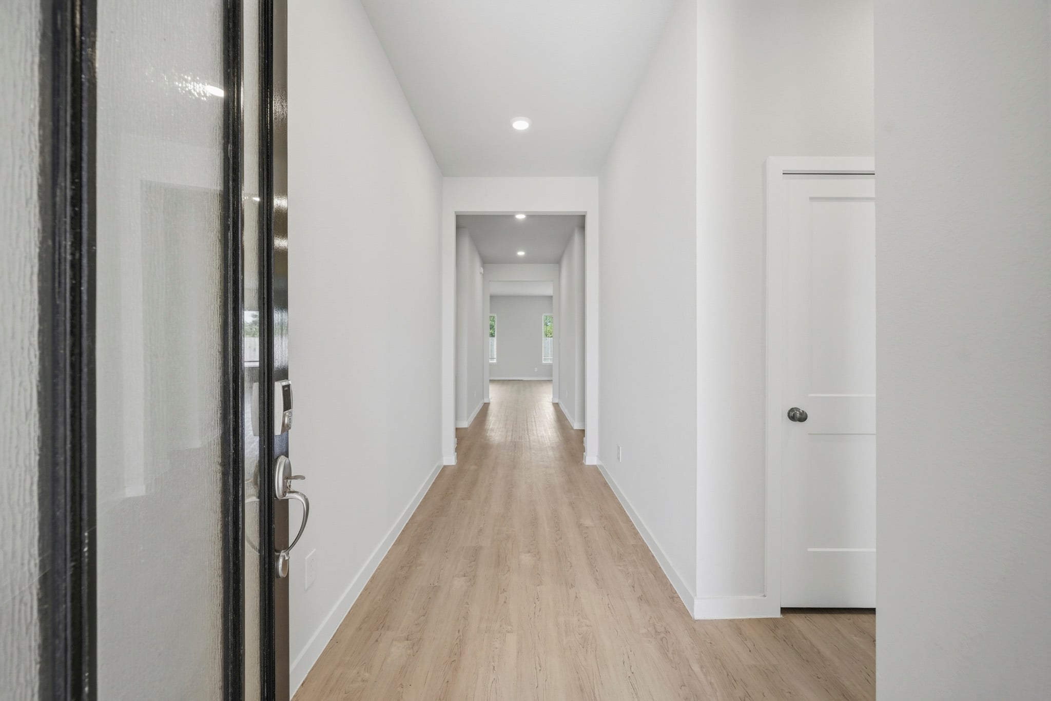 A hallway with white doors.