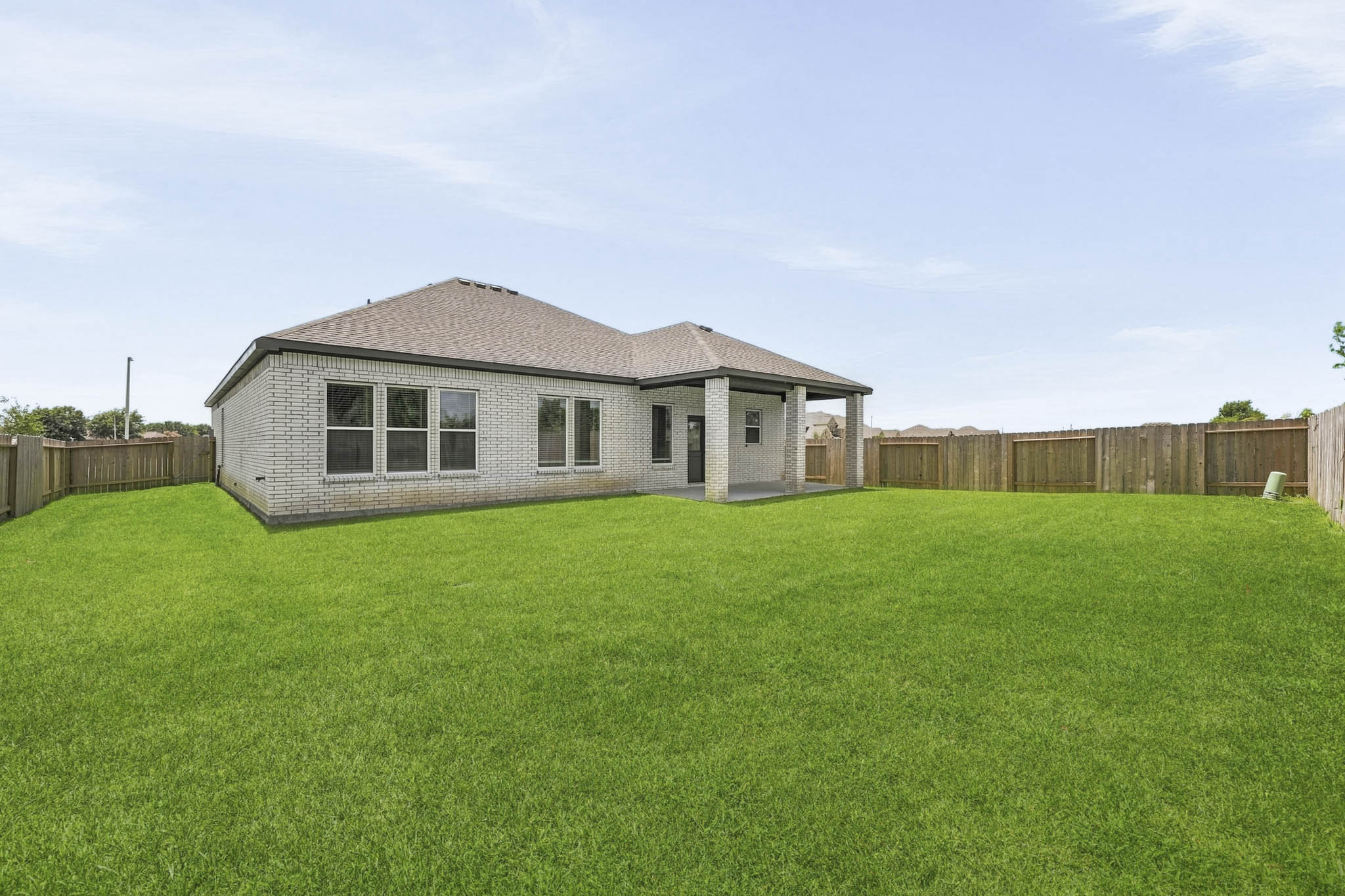 A house in a grassy field.
