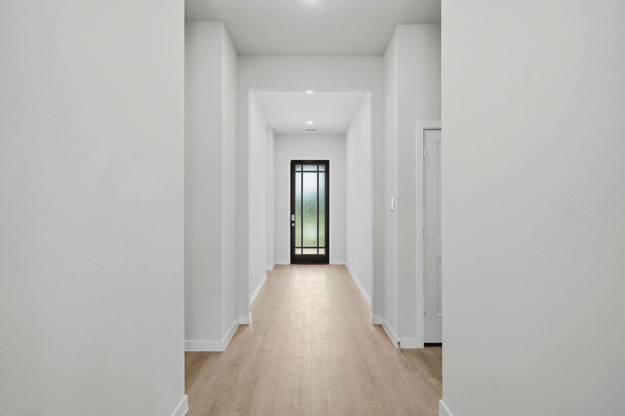 A hallway with white walls.