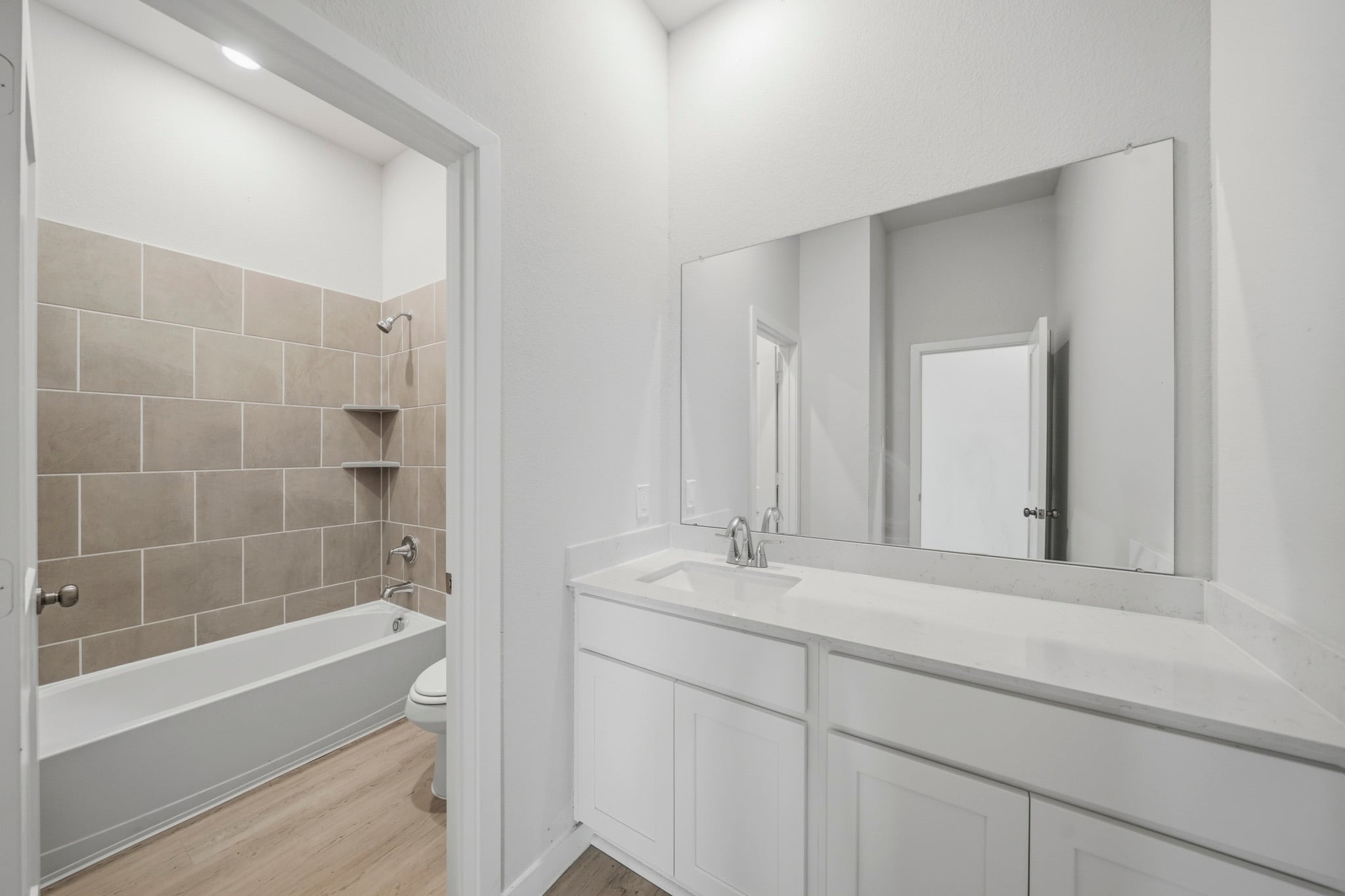 A bathroom with a tub sink and toilet.