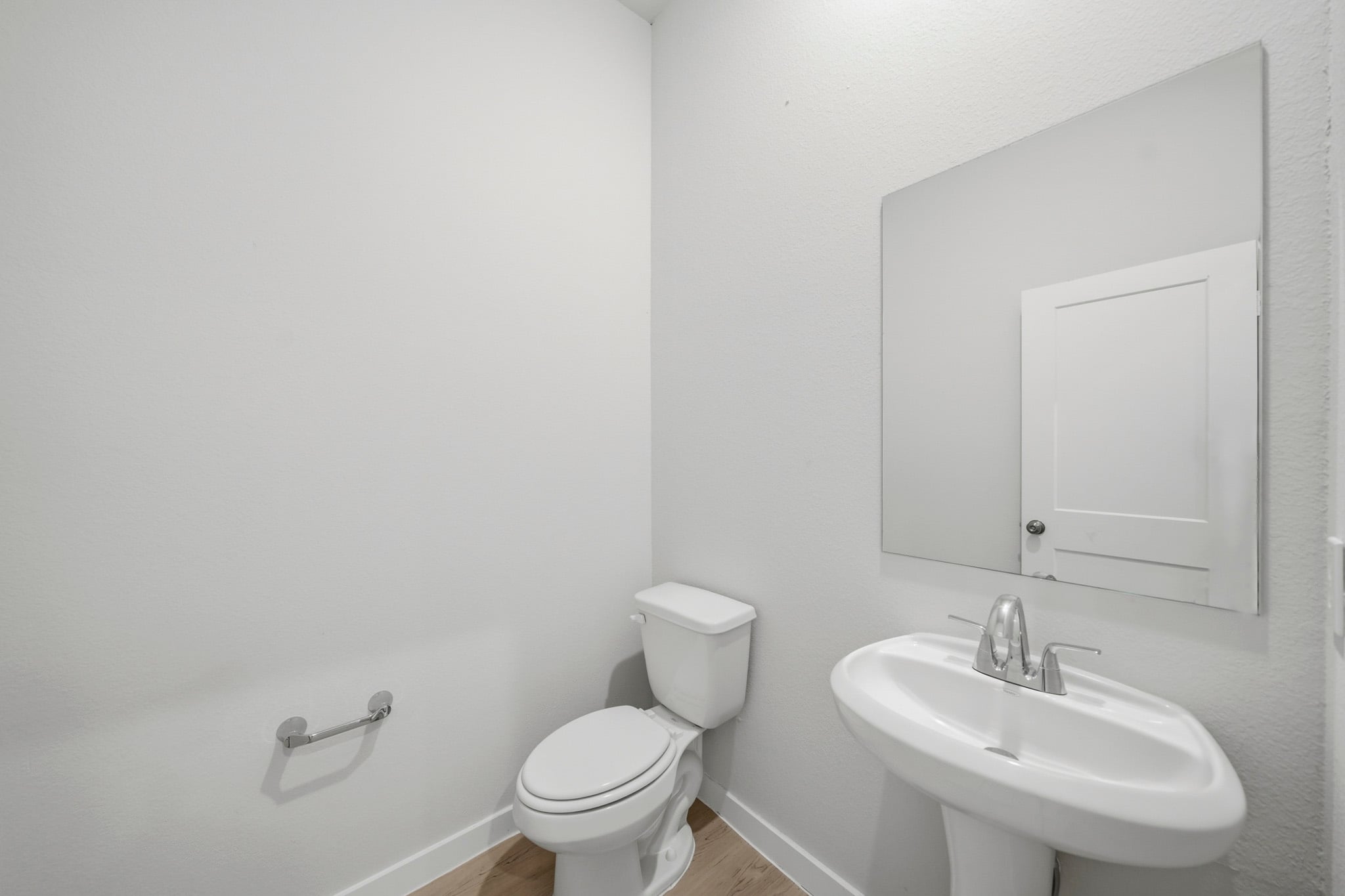 A bathroom with a toilet and sink.