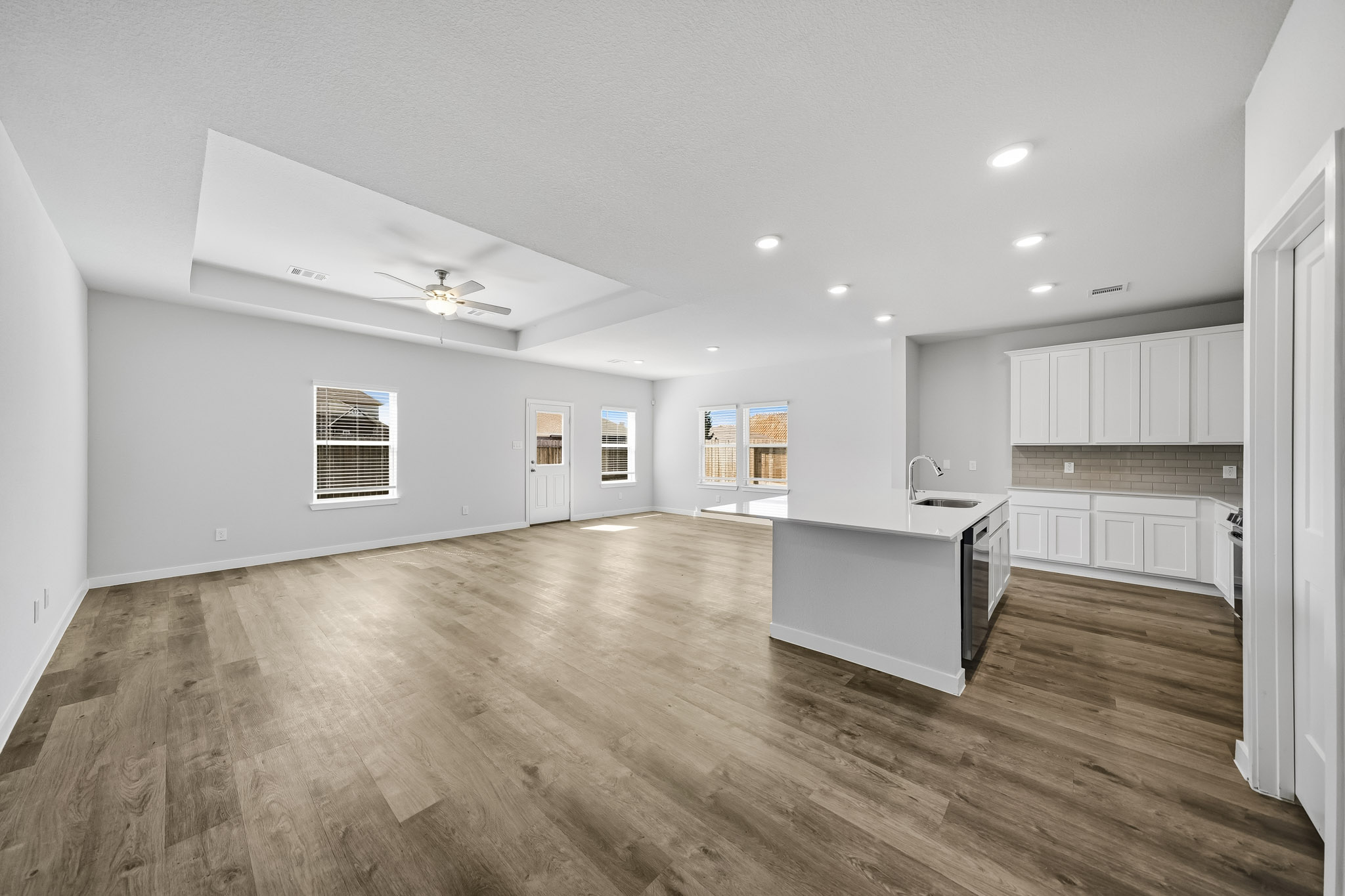 A large kitchen with white cabinets.