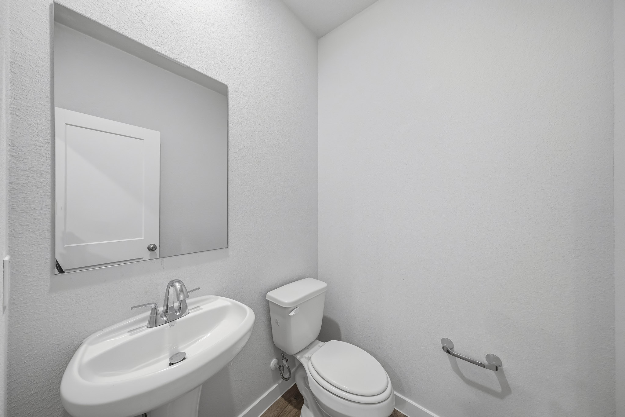 A bathroom with a toilet and sink.