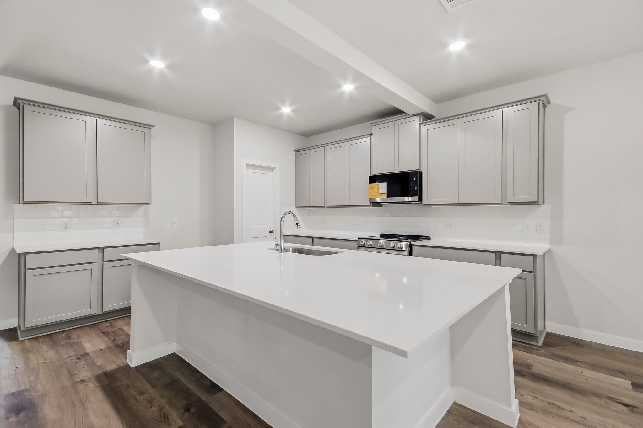 A kitchen with white cabinets.