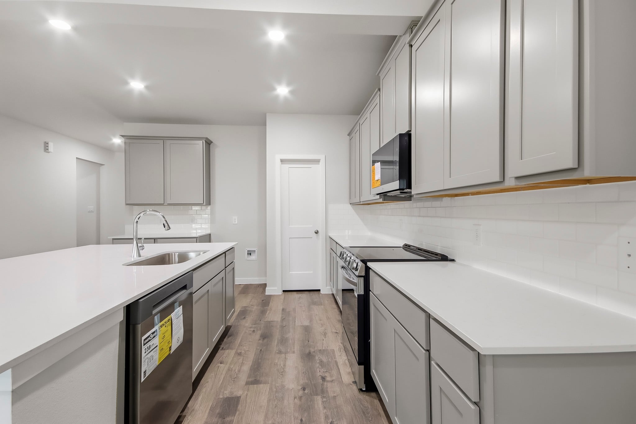 A kitchen with white cabinets.