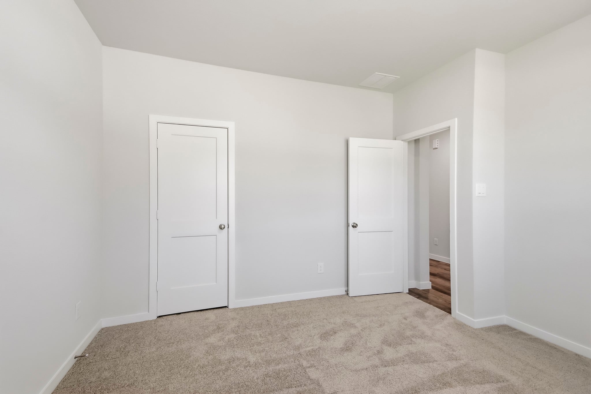 A hallway with white doors.
