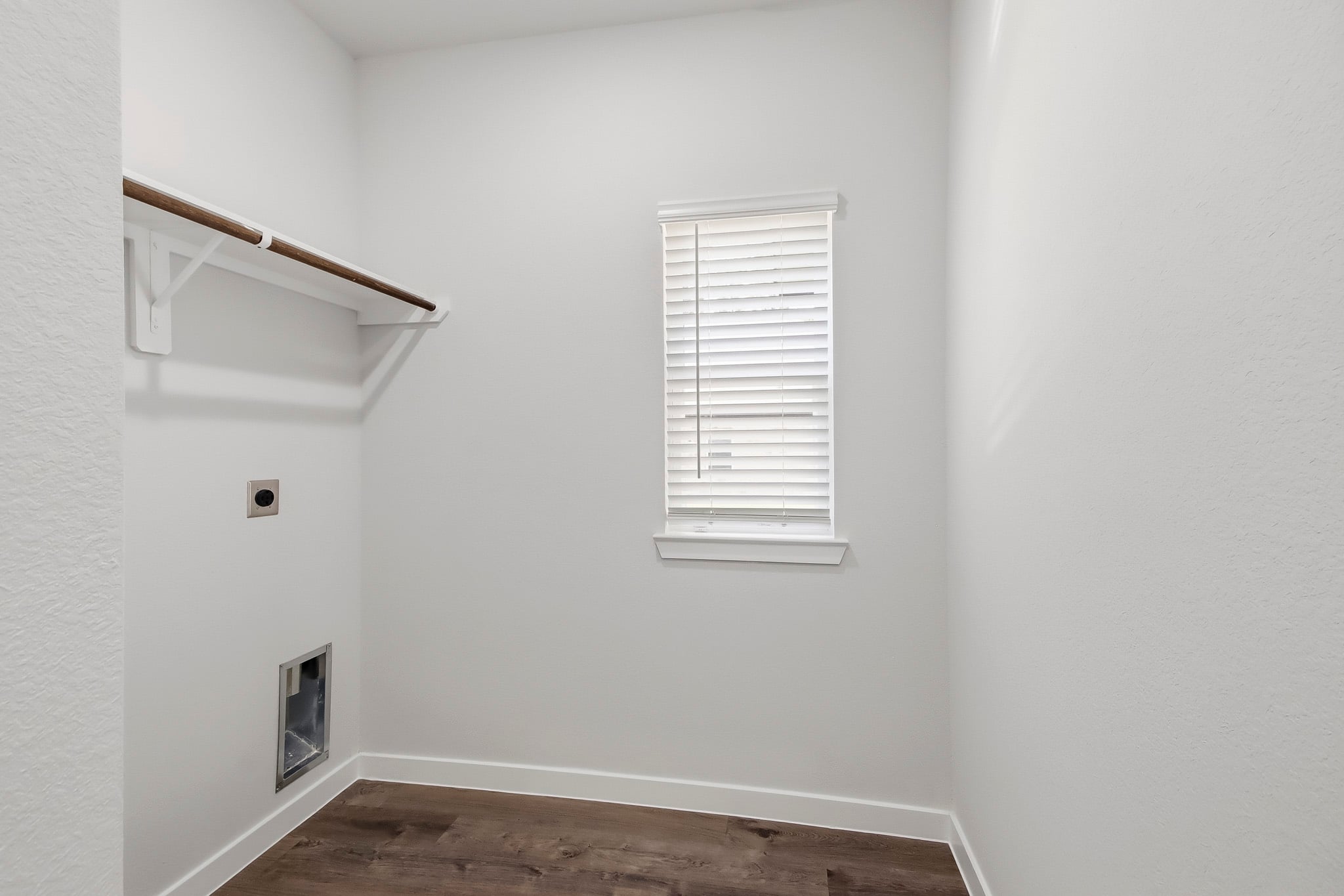 A white room with a window.