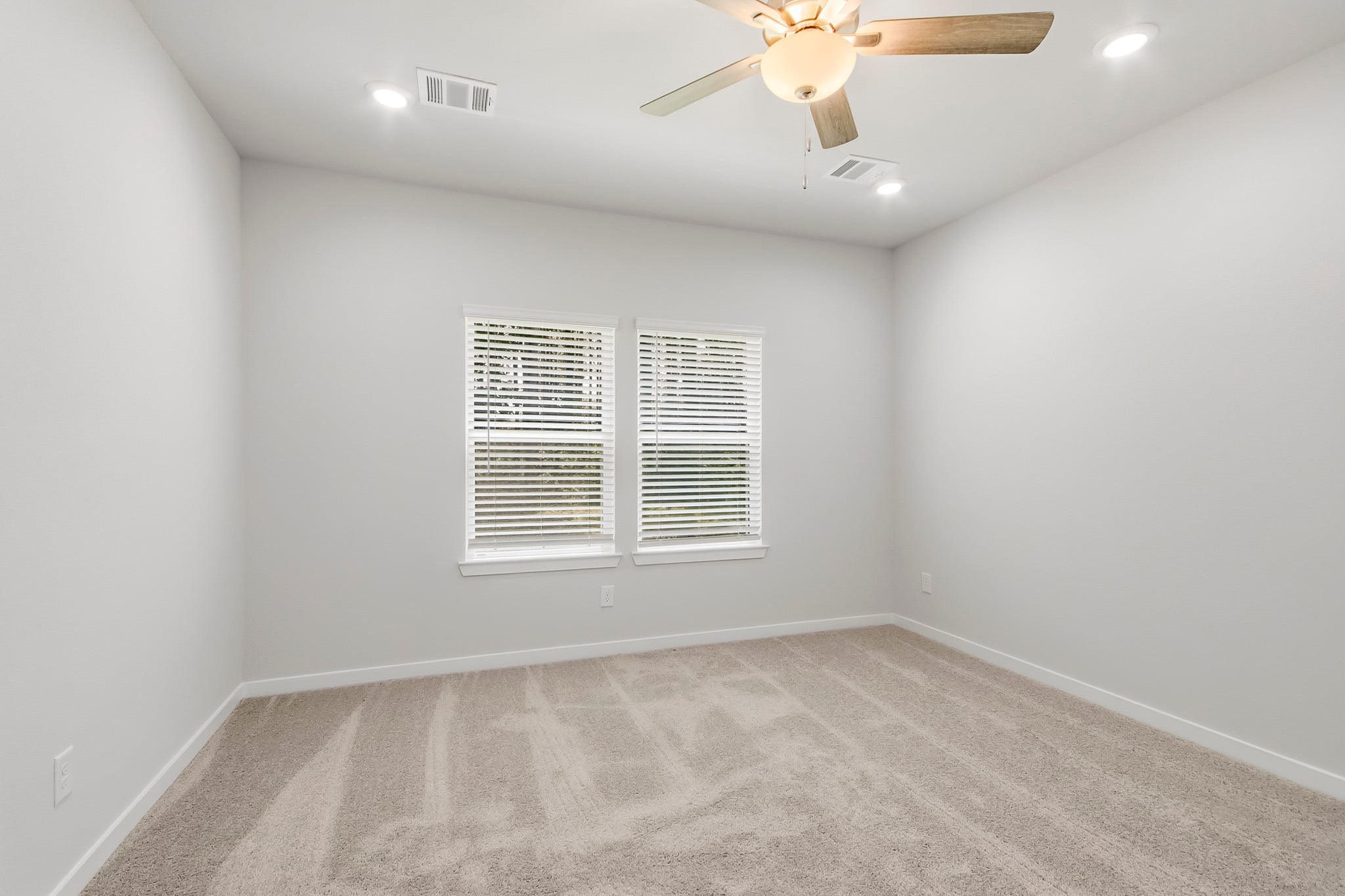 A room with a ceiling fan and a ceiling fan.