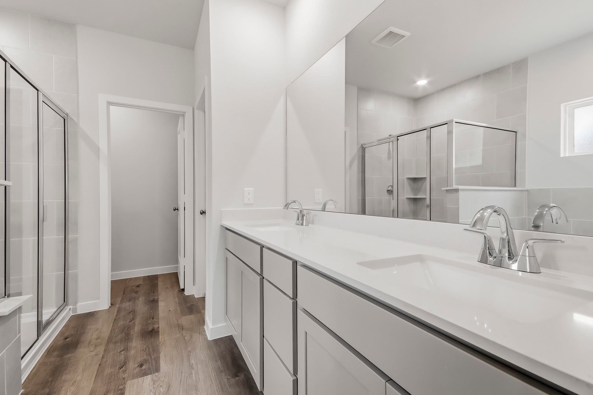 A bathroom with a large mirror.
