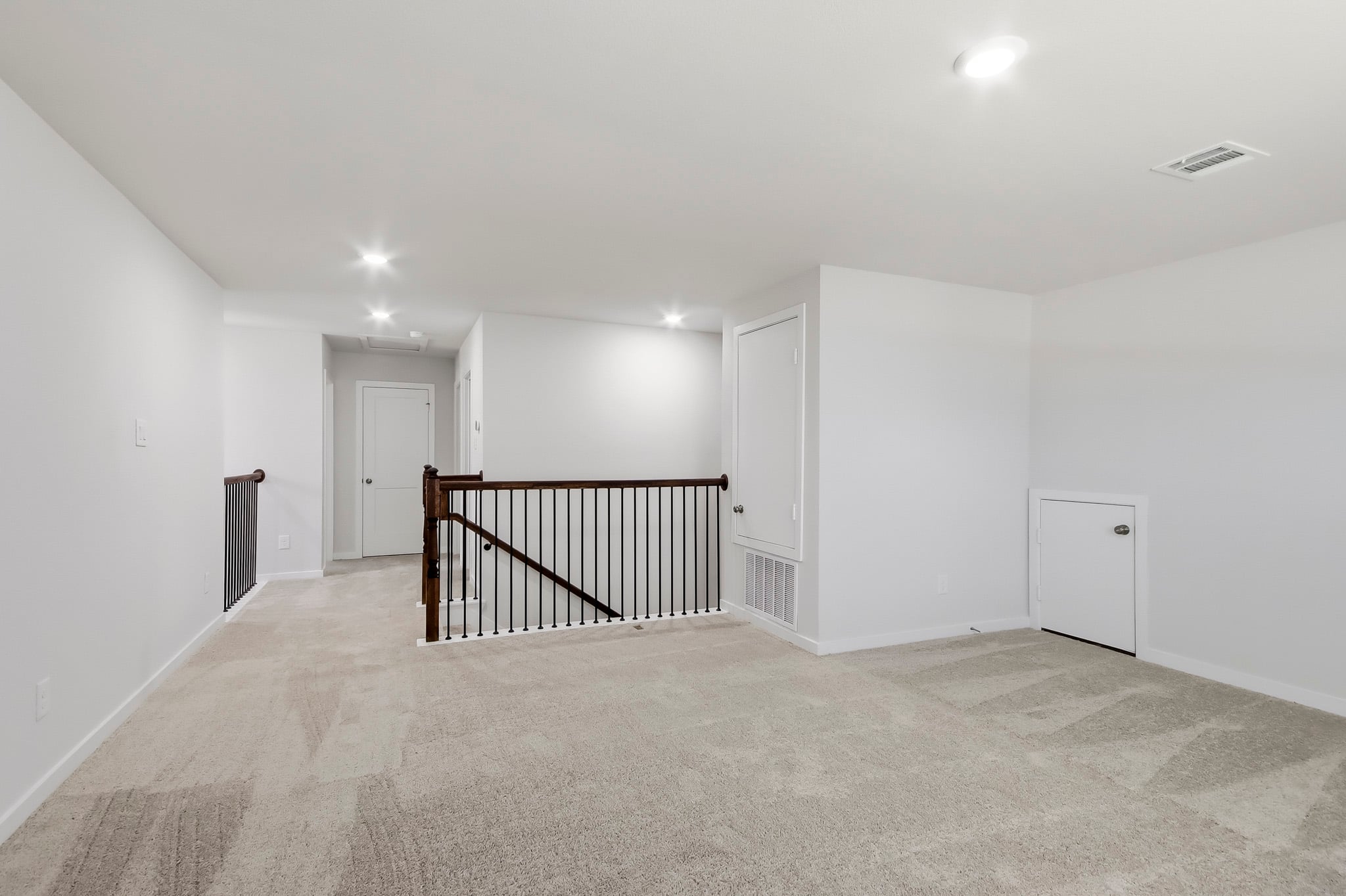 A room with a staircase and white walls.