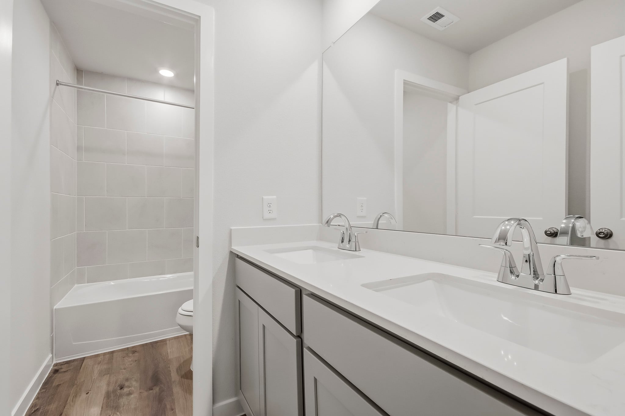 A bathroom with a tub sink and toilet.