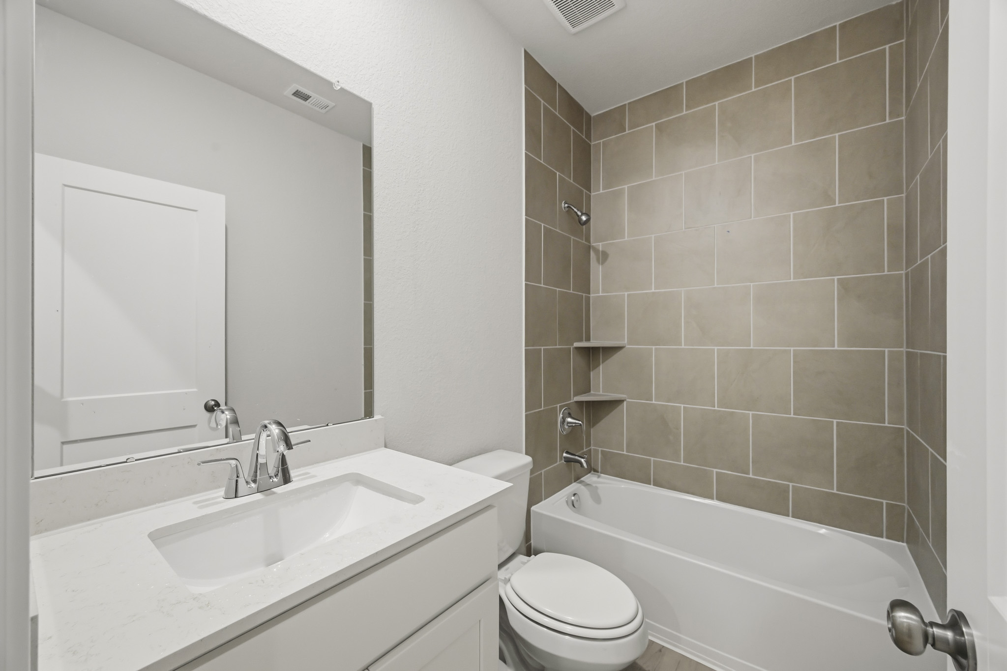 A bathroom with a tub sink and toilet.