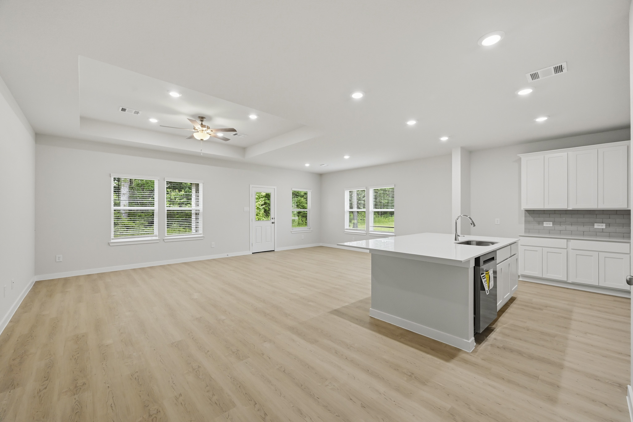 A large kitchen with white cabinets.