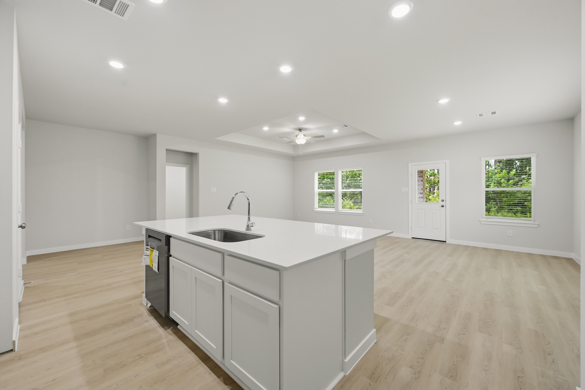 A kitchen with white cabinets.