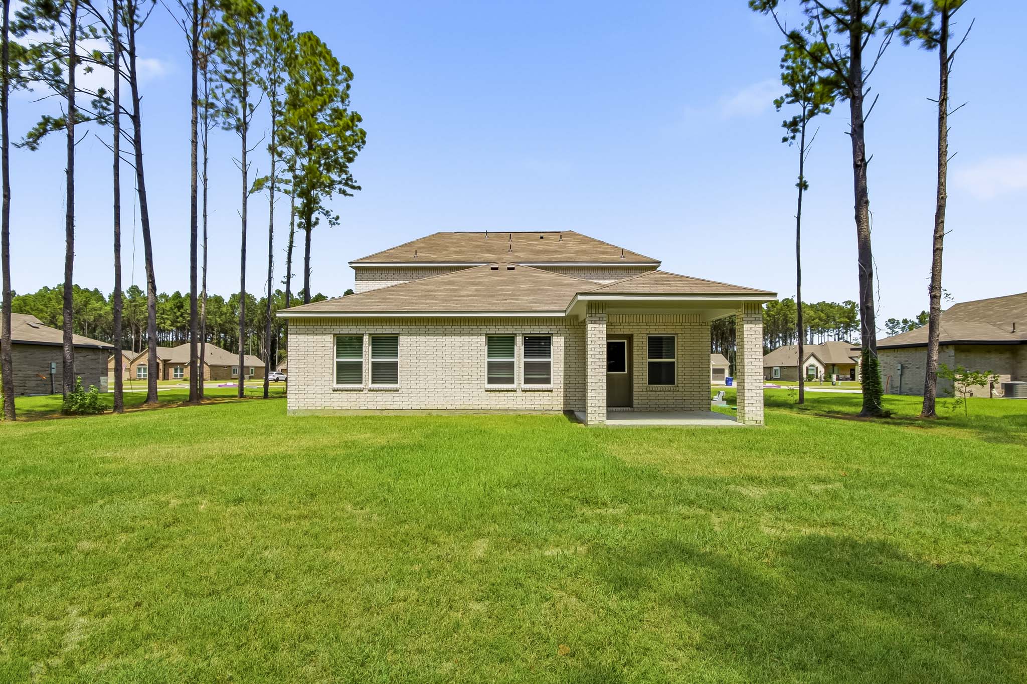 A house with trees in the front.