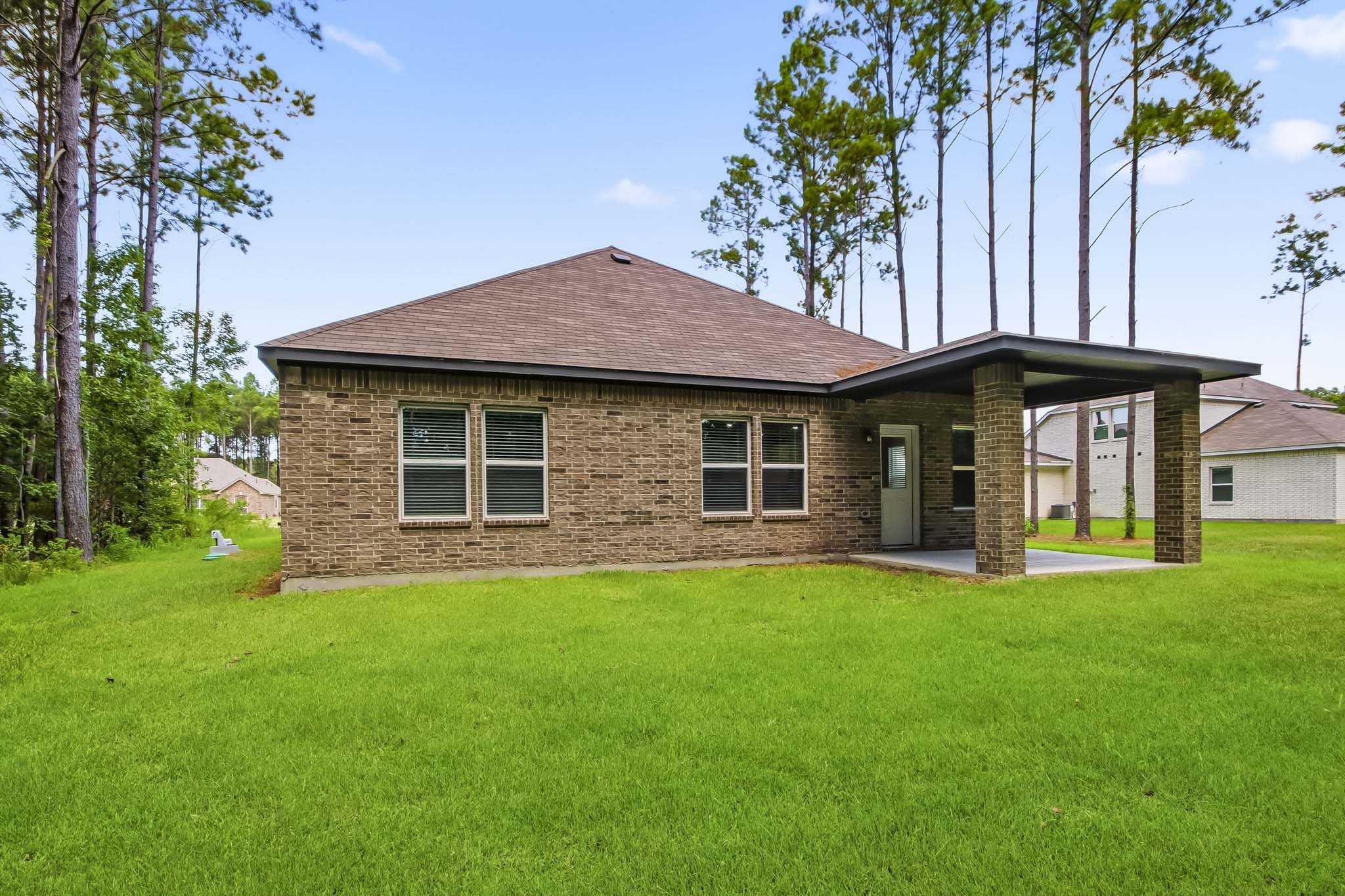 A house with a grass yard.