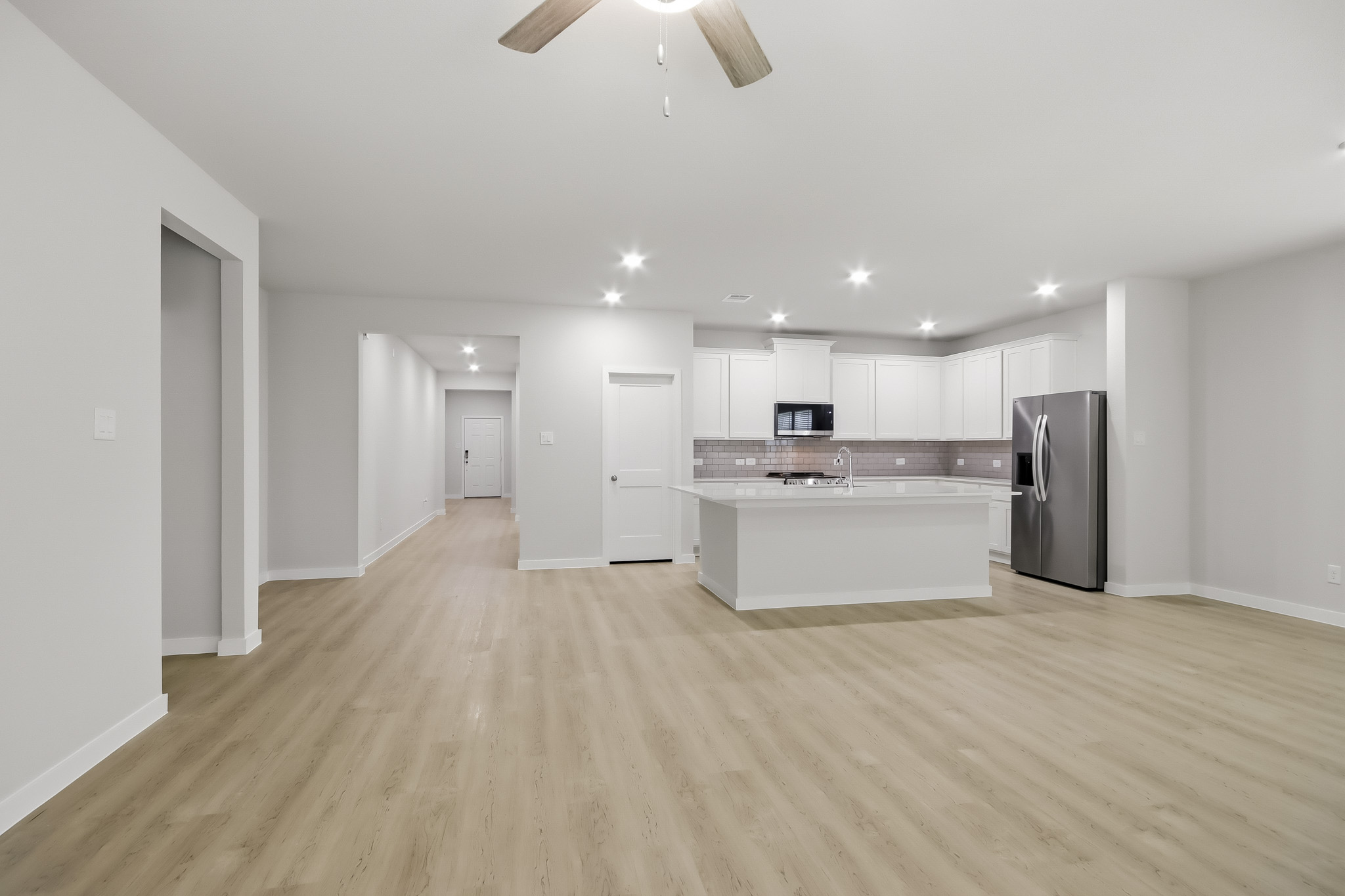 A large kitchen with white cabinets.