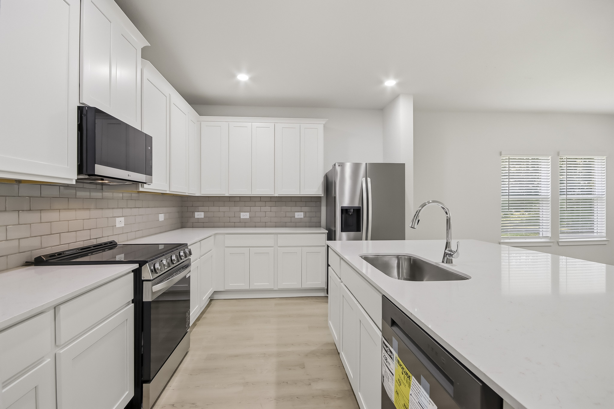 A kitchen with white cabinets.