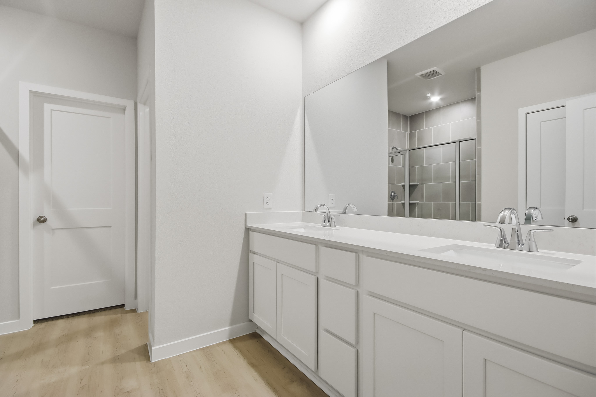 A bathroom with a large mirror.