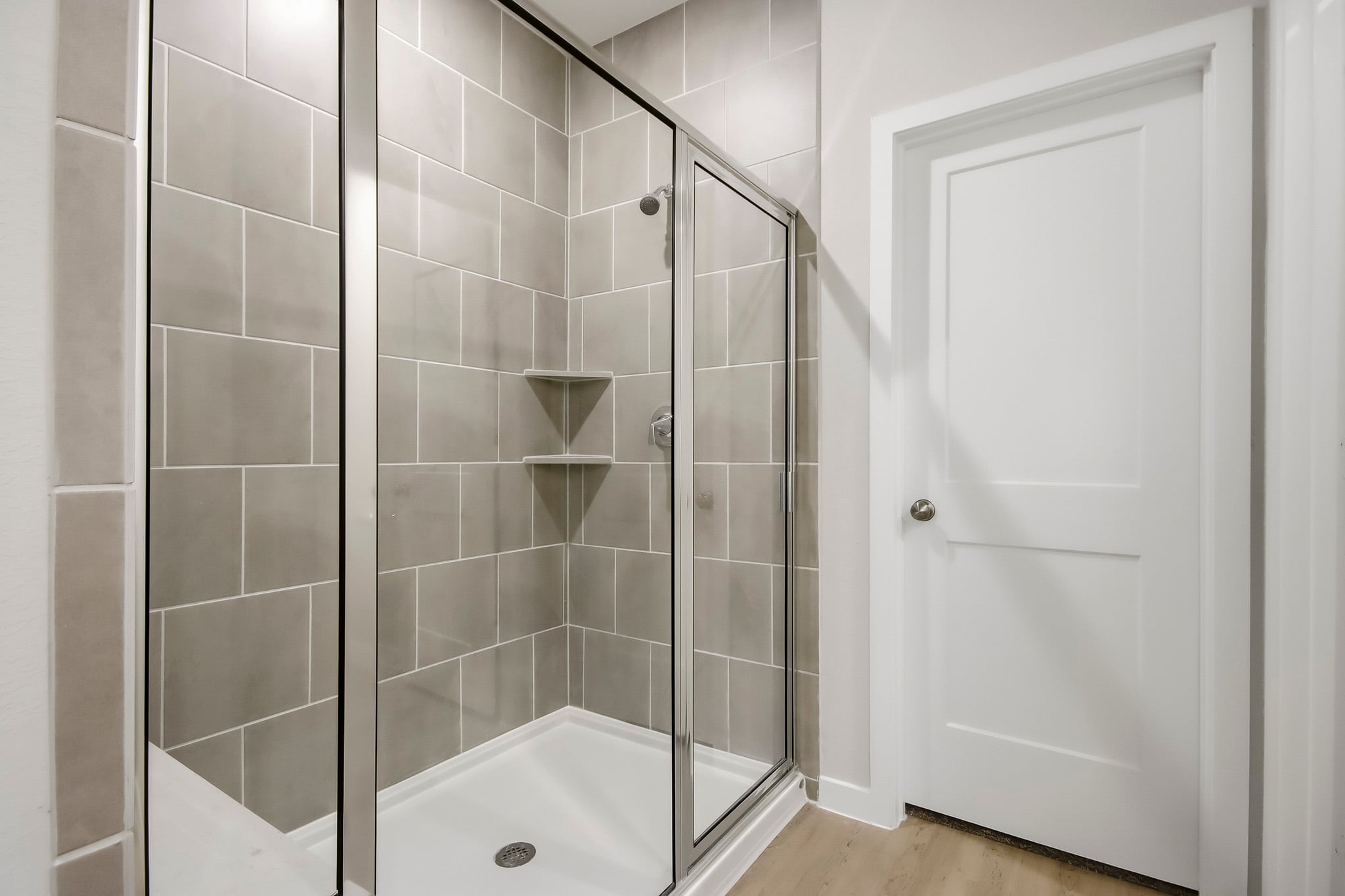A shower with a glass door.