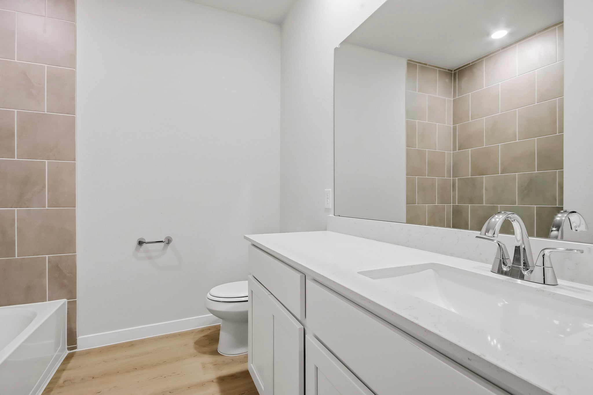 A bathroom with a tub sink and toilet.