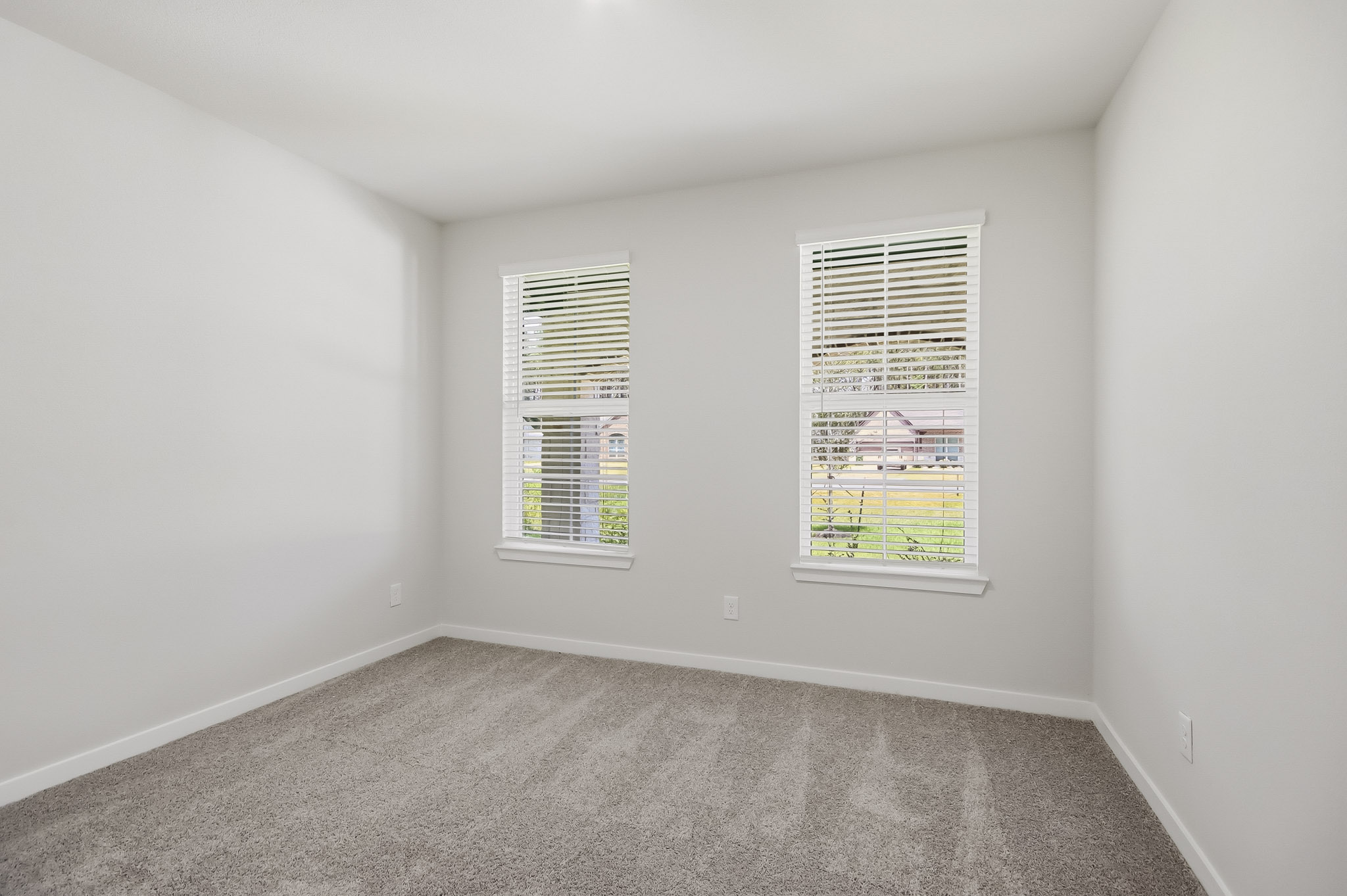 A room with a window and a carpet.