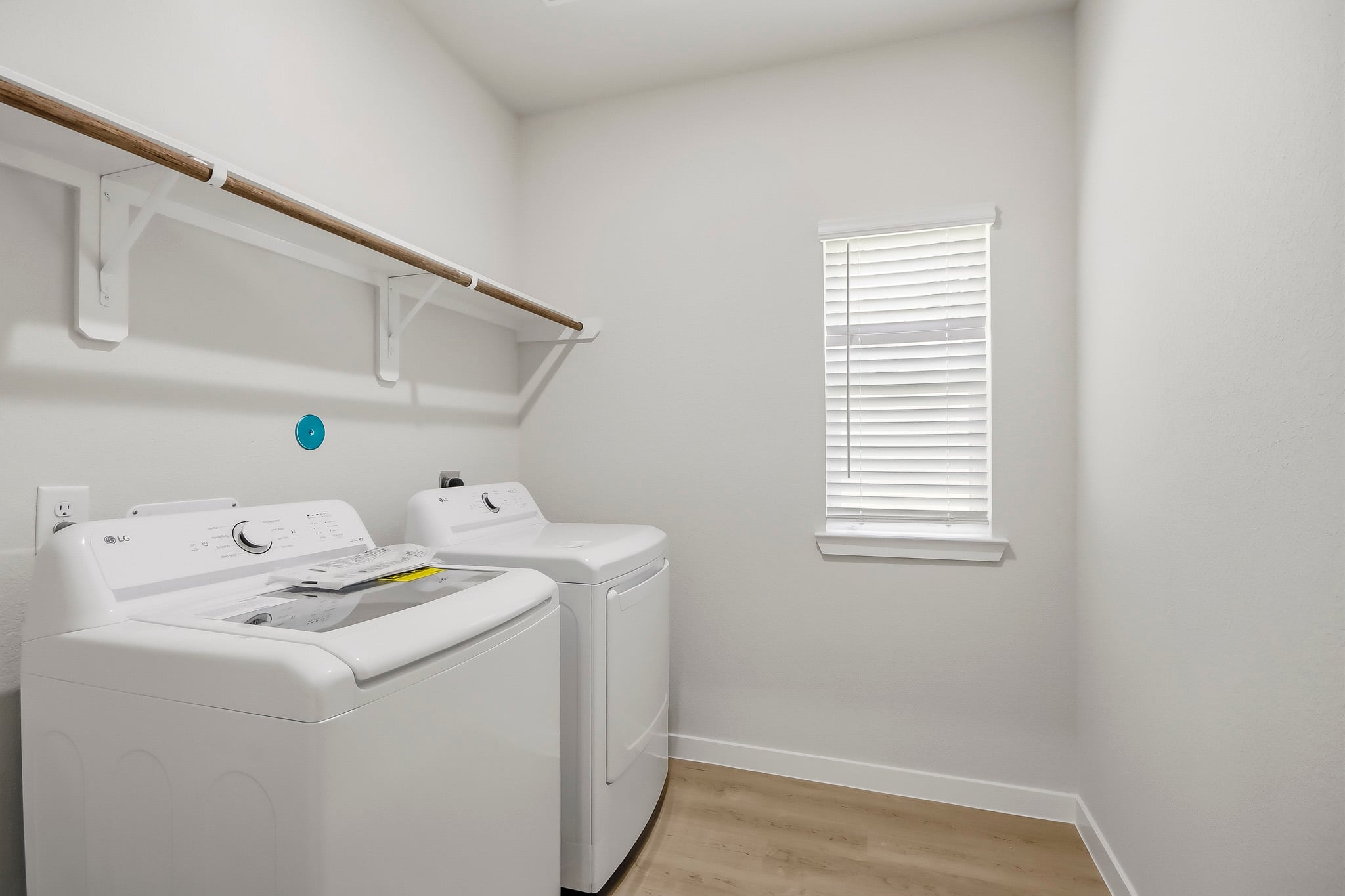 A room with a white wall and a white shelf with a white radiator and a white.