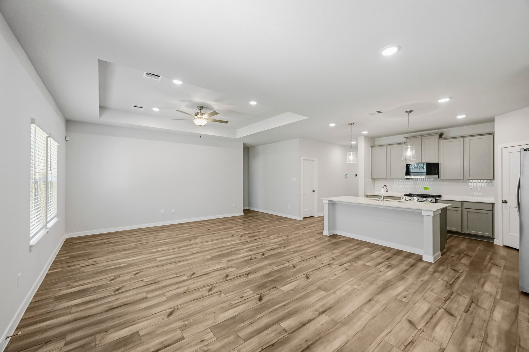 A kitchen with a wood floor.
