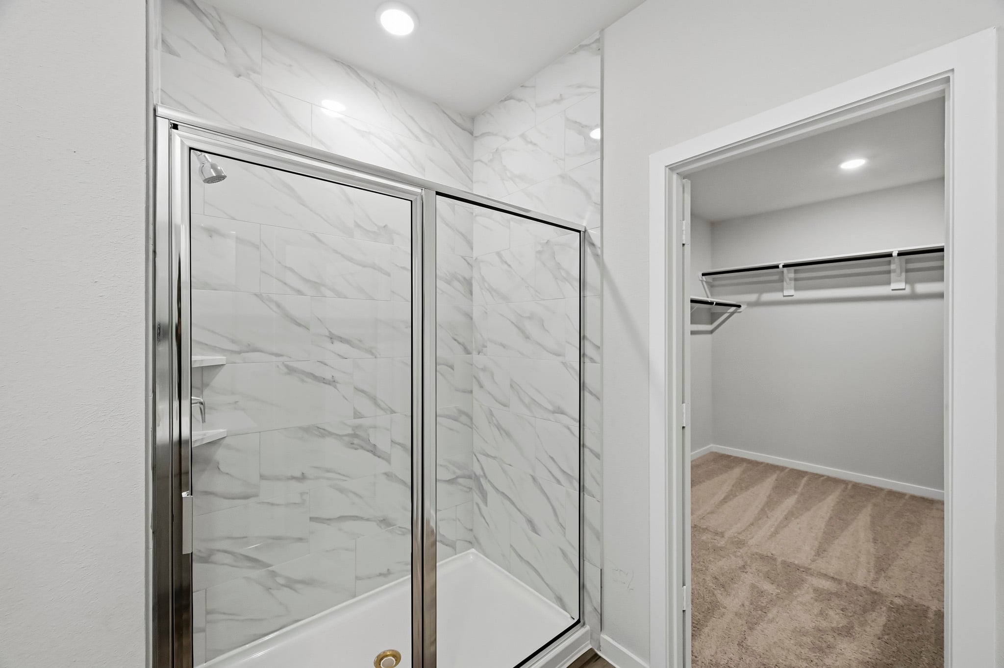 A shower with a glass door.
