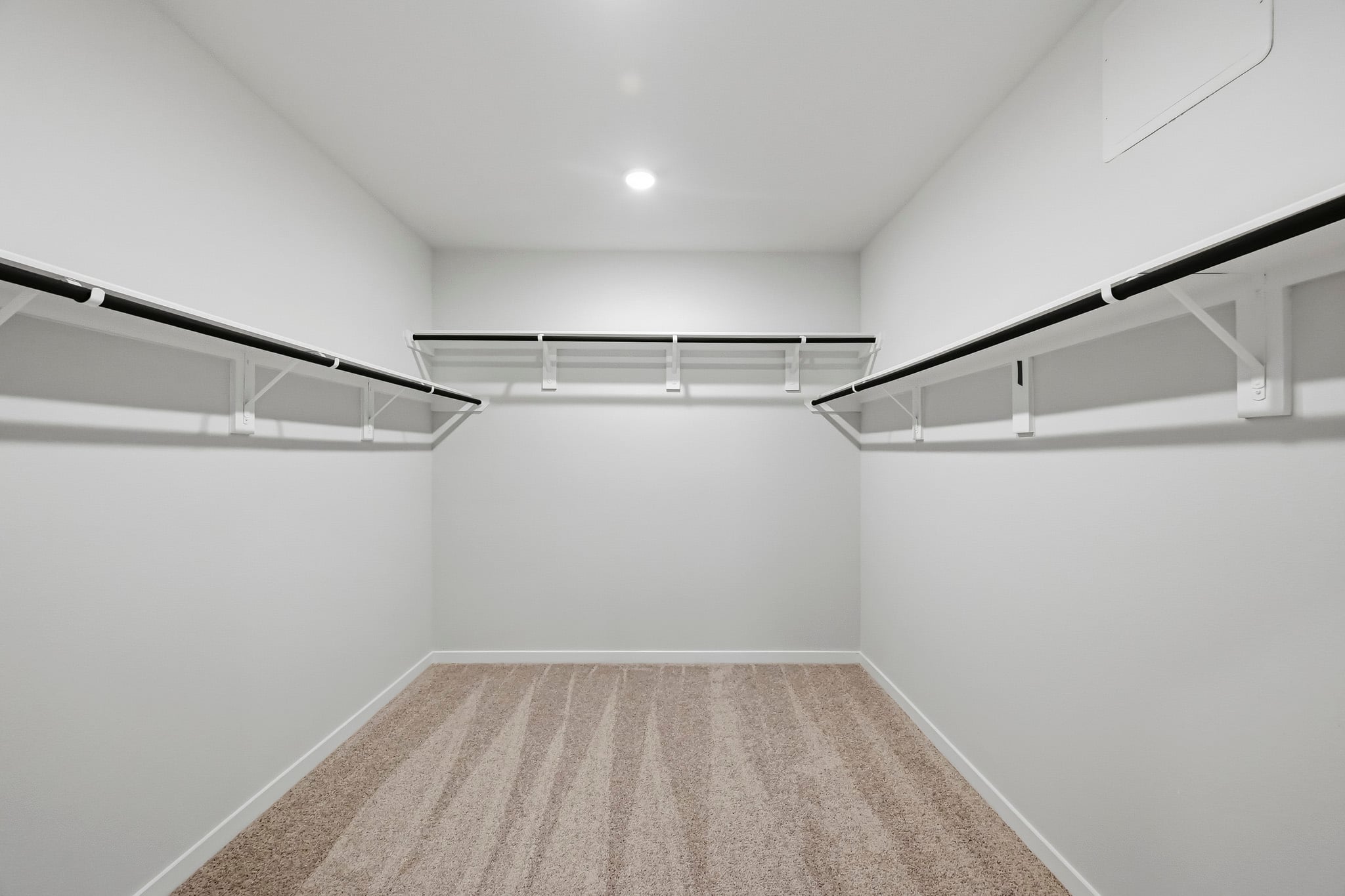 A white room with a carpet.