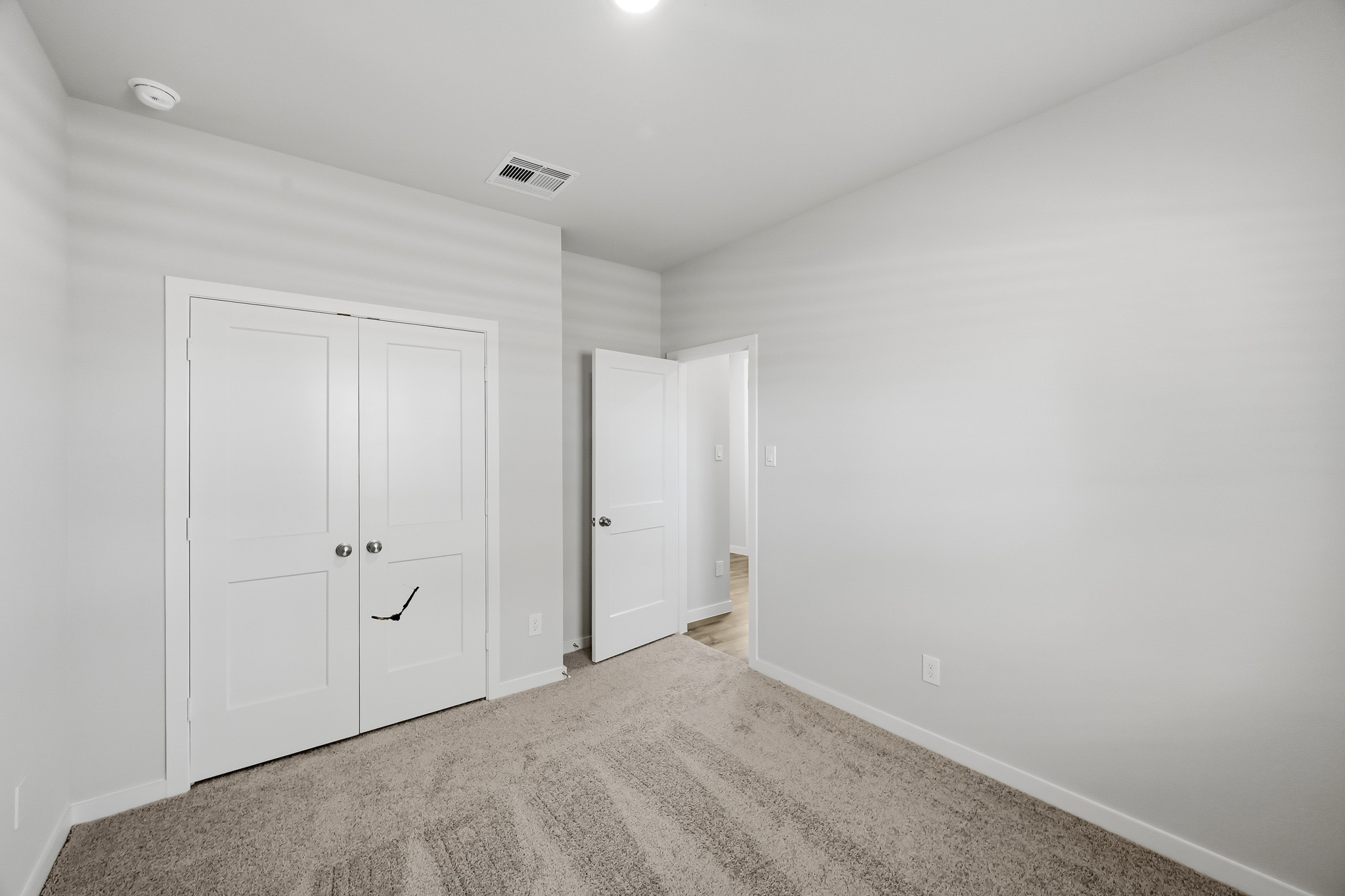 A hallway with white doors.