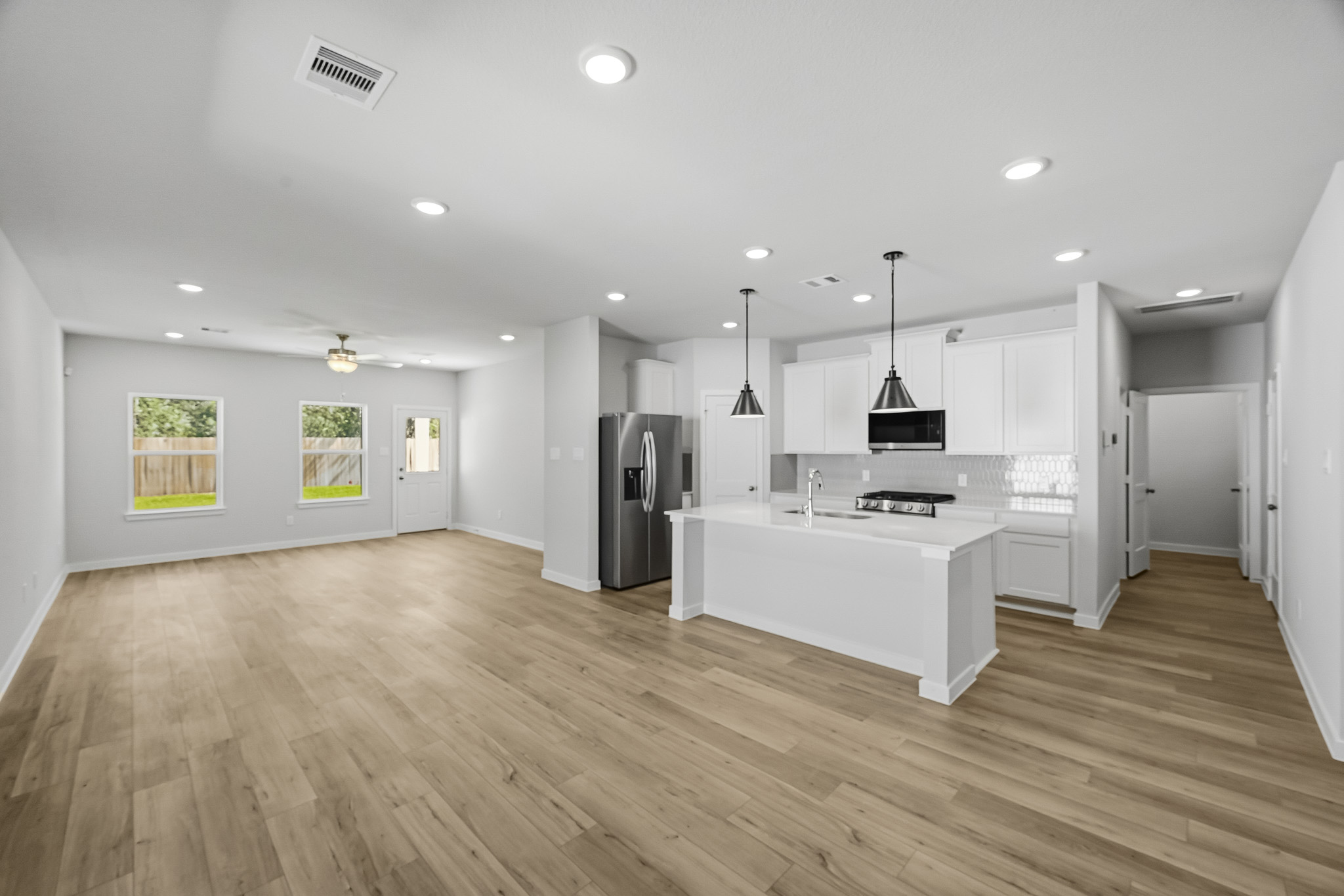 A large kitchen with white cabinets.