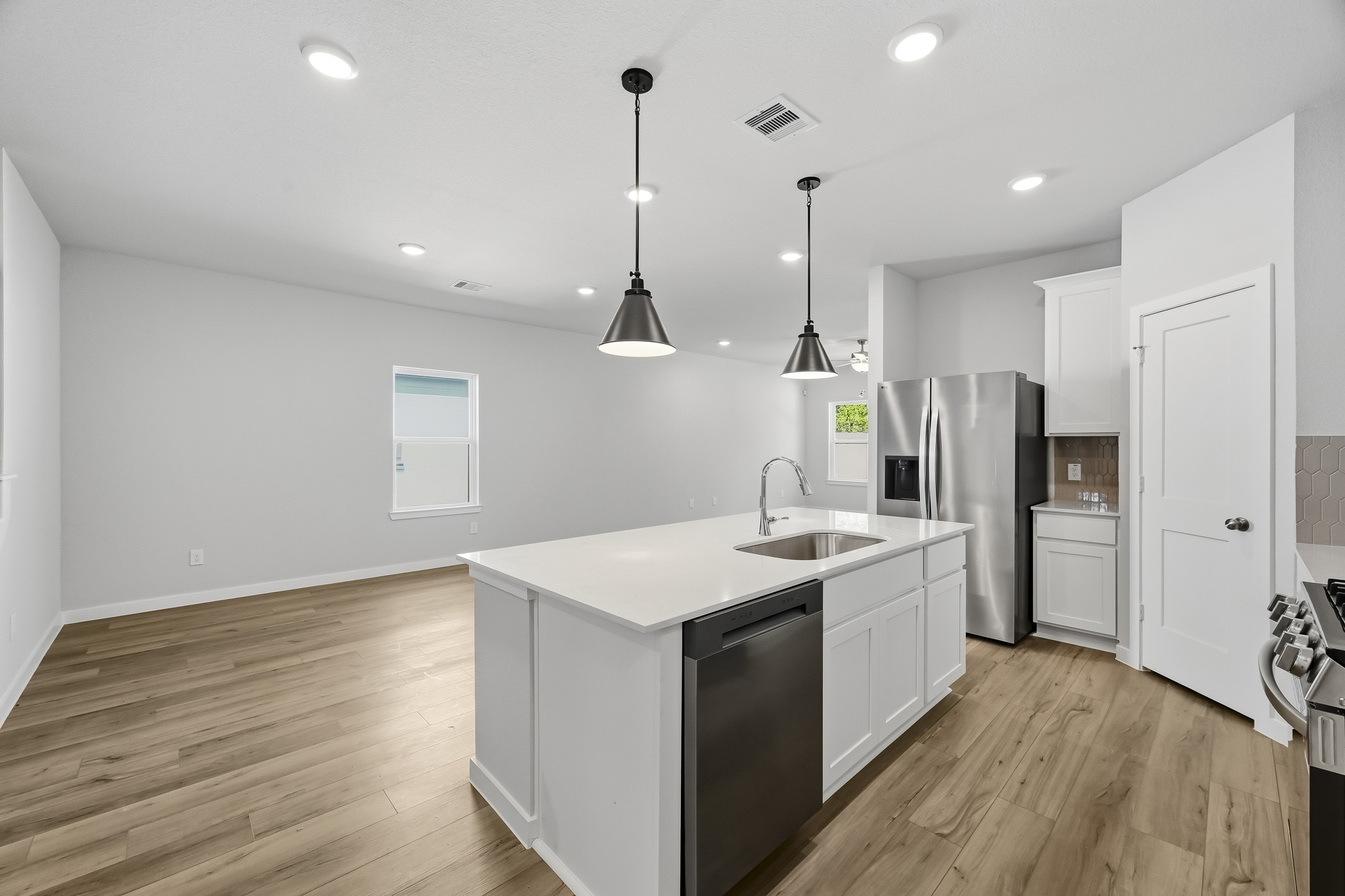 A kitchen with white cabinets.