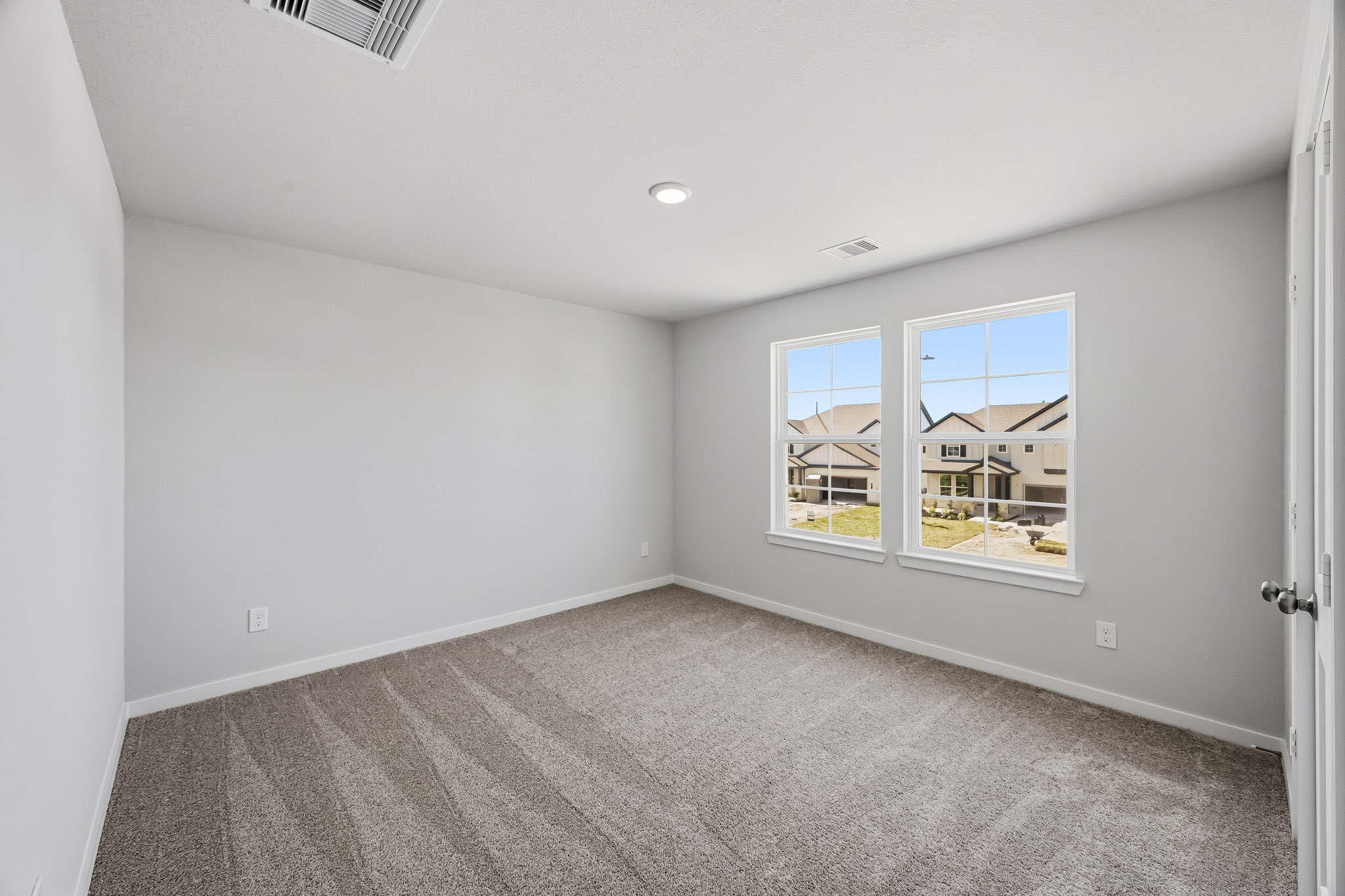 A room with a window and a door.