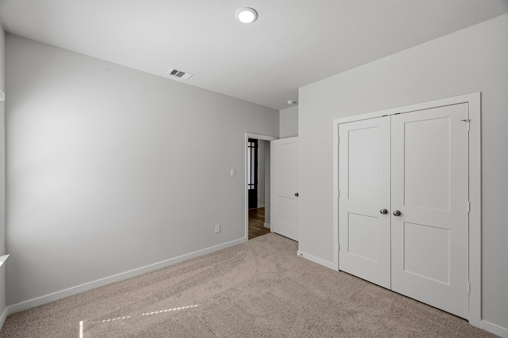 A hallway with white doors.