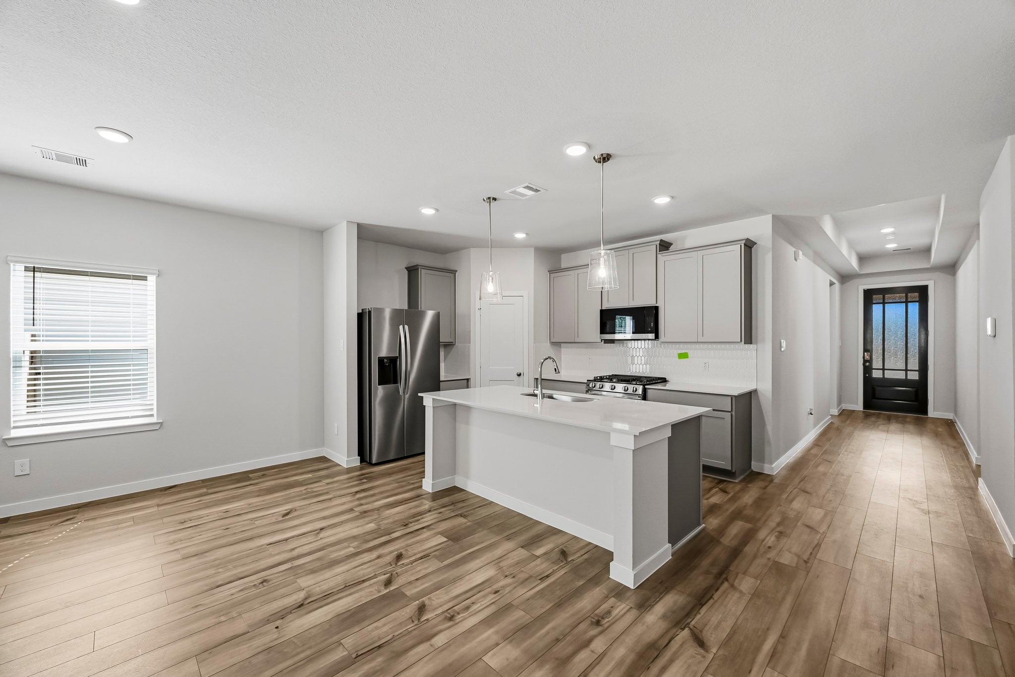 A kitchen with a wood floor.