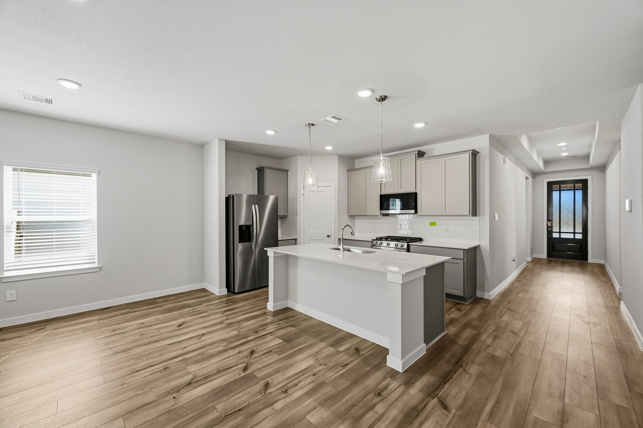 A kitchen with a wood floor.