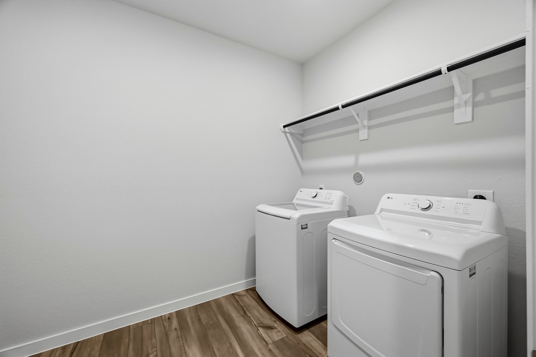 A room with a white wall and a white machine.