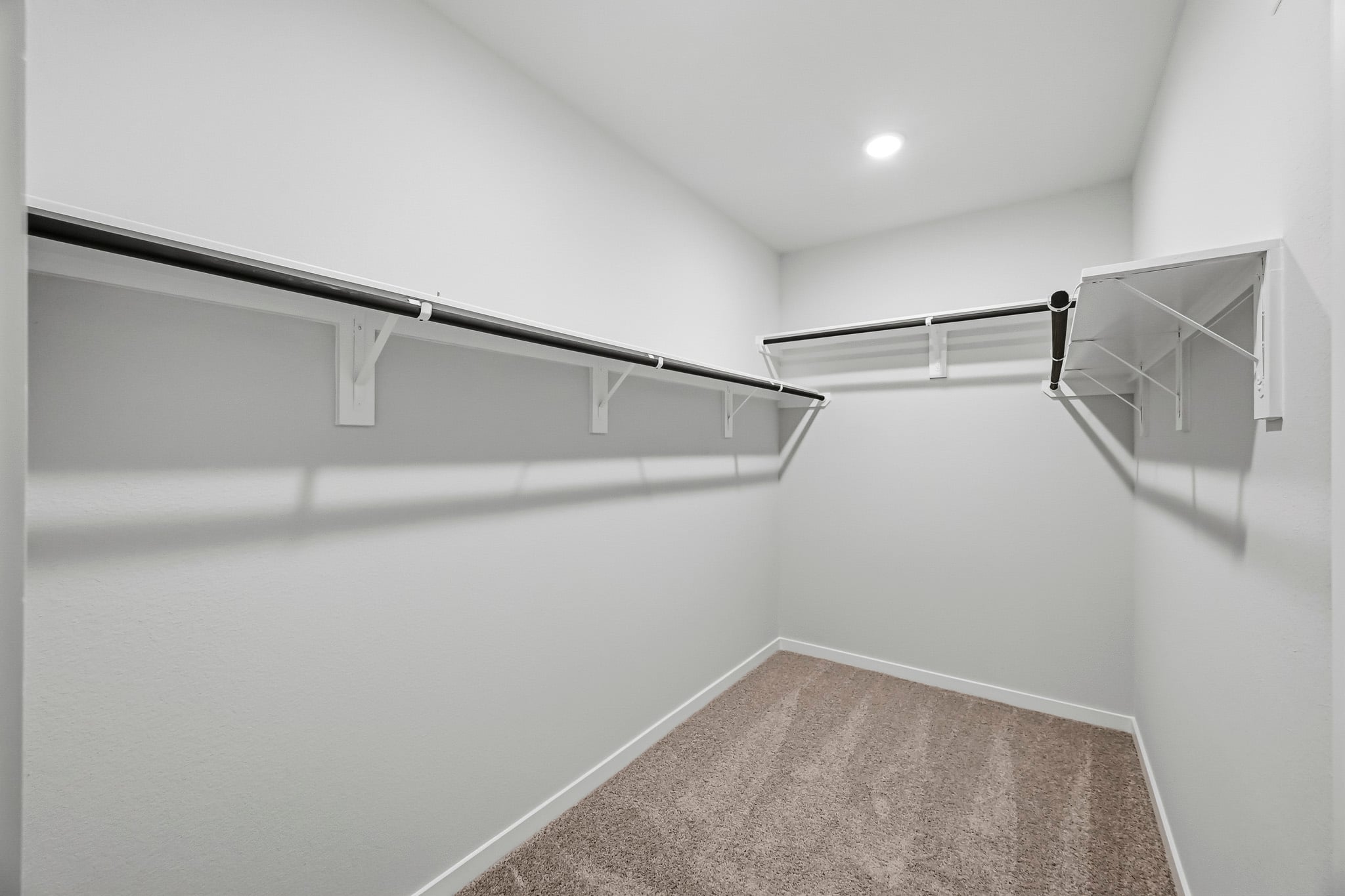 A hallway with a metal railing.